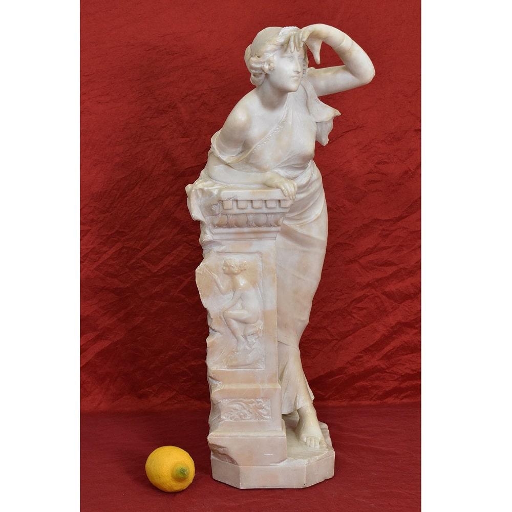 The category Antique Alabaster Sculptures, features a refined Female Sculpture, a 
Young Woman leaning against a classical column and peering expectantly, 
the work created is made of alabaster, a lustrous and elegant material used by the 
artists