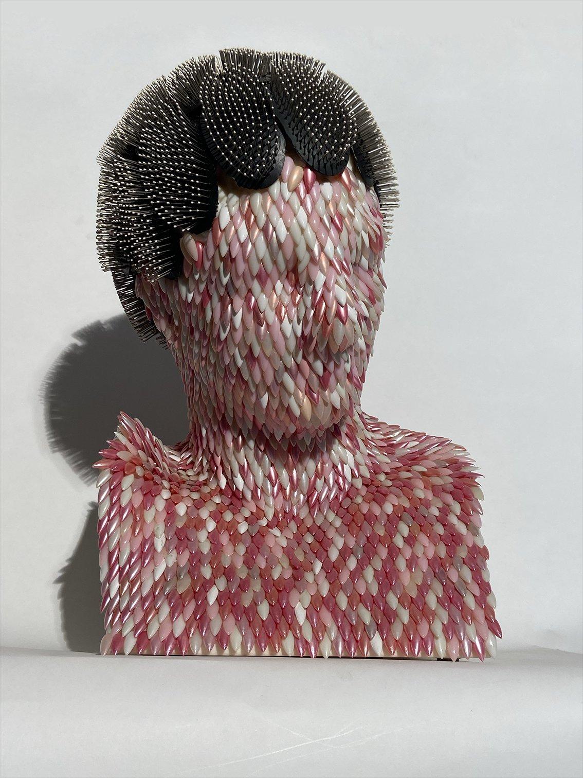 Scultura realizzata da Enrica Borghi nel 1999 e prodotta da Telcom a Ostuni, Italia. La scultura rappresenta un busto di uomo ed è realizzata con una struttura in materiale plastico, rivestita esternamente da unghie finte colorate che vanno a