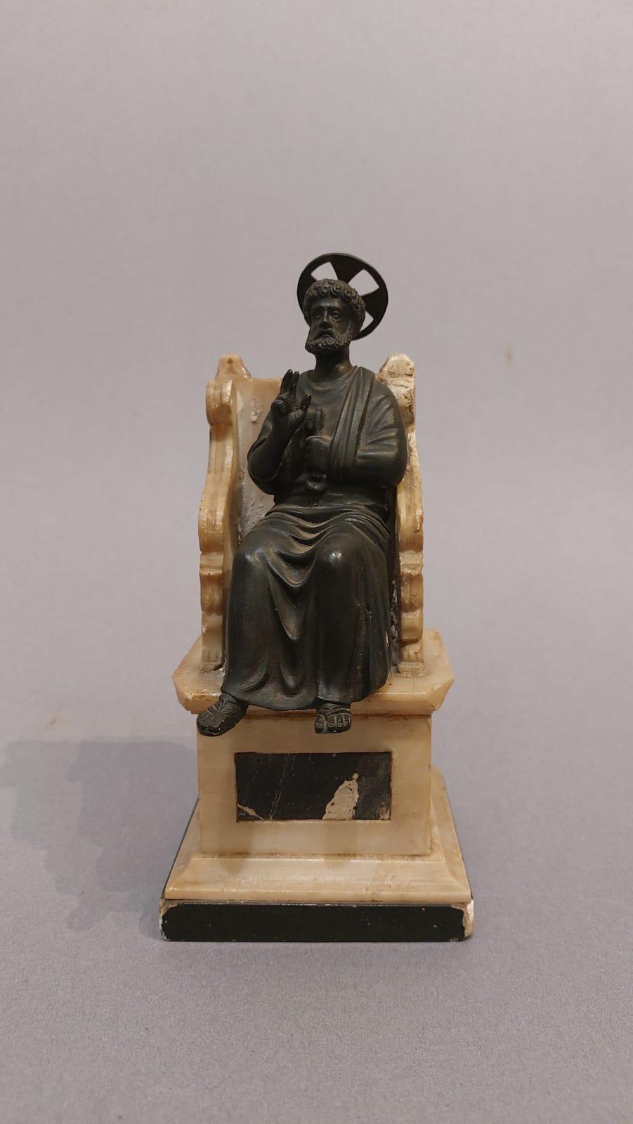Miniature reproduction of the 13th-century statue of St. Peter in the Chair attributed to Arnolfo di Cambio, located inside St. Peter's Basilica in the Vatican. 
The item was undoubtedly a 19th-century souvenir for pilgrims visiting Rome in the Holy