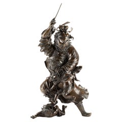 Scultura in bronzo raffigurante Shoki con una coppia di oni