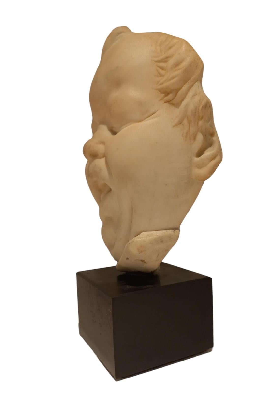 White marble sculpture depicting the face of a child with a grimace, 19th century, height of sculpture alone 23 cm, width 17 cm, black Belgium base is 7 cm high and has a size of 10x10 cm.
The sculpture is not signed.