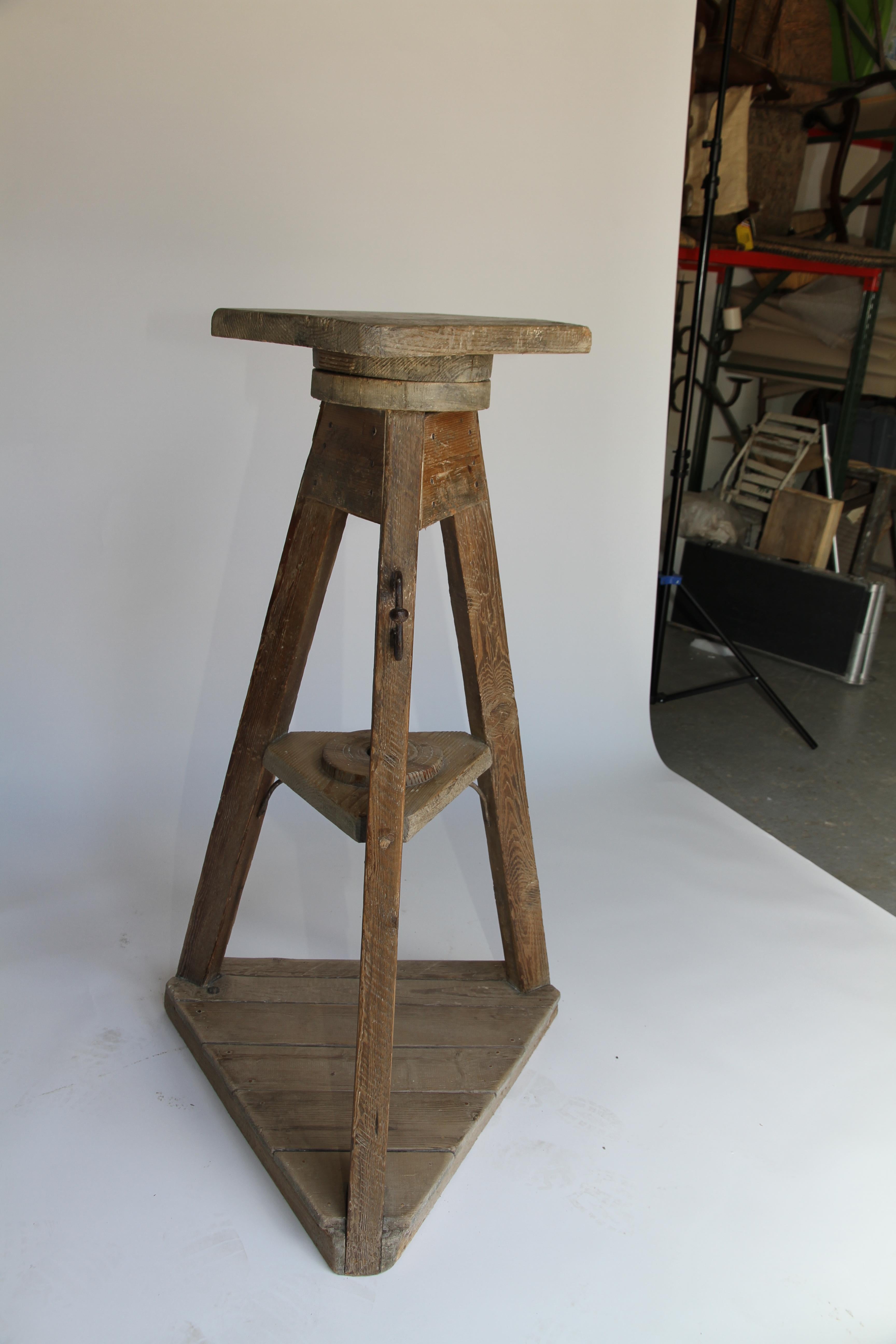 An old sculptor's table finds a new life as a captivating stand, display your art or as a piece of art itself. Found in France, a wooden base supports a revolving work surface with the entirety cleaned and waxed to a reveal a beautiful patina. On a