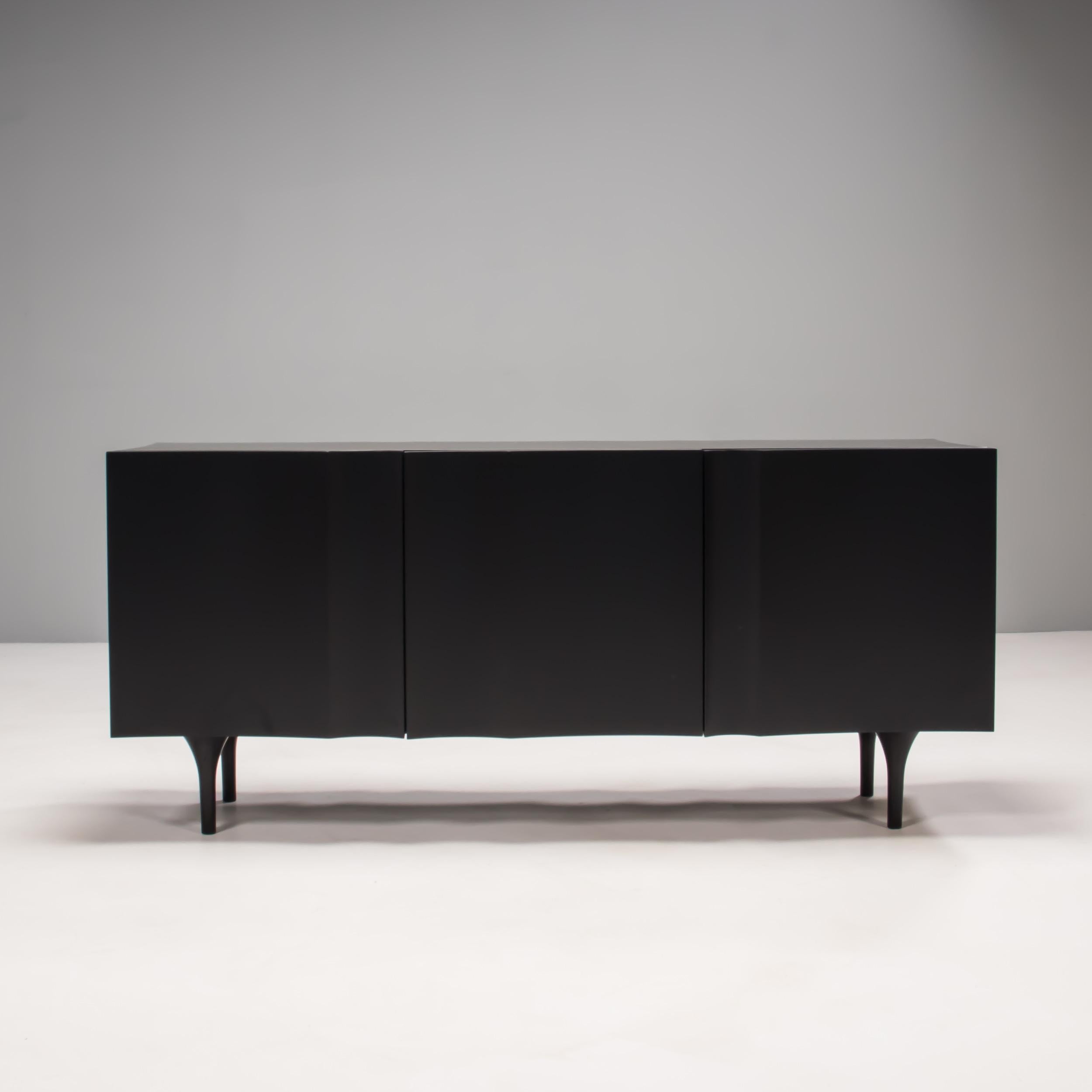 Designed by Damien Langlois-Meurinne for Sé, this commode features a dark and striking silhouette, revealing fine craftsmanship in its wooden frame, lacquered interior and exquisitely-tapered legs.

The fold motif on its silky surface evokes ones