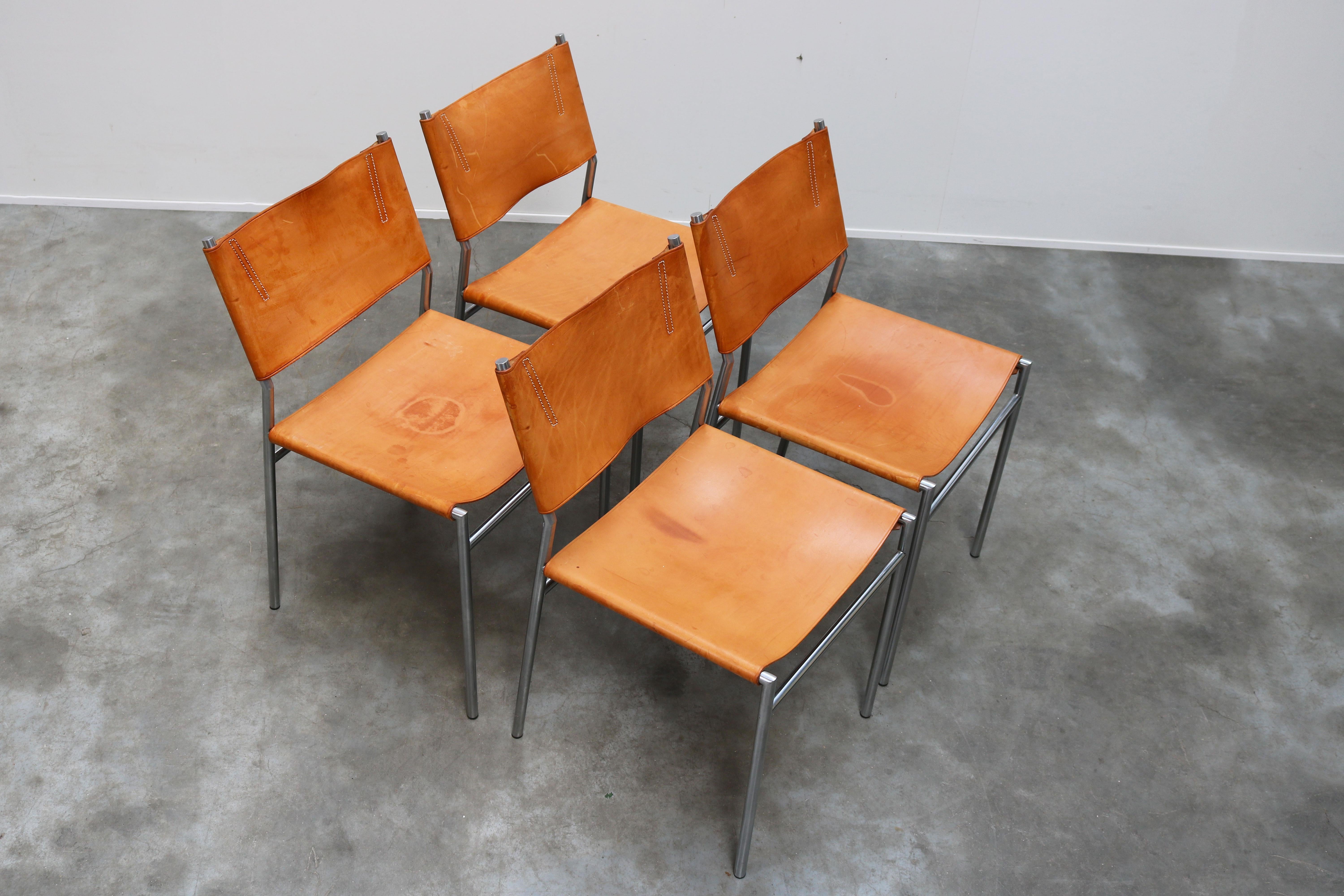 Magnificent pair of SZ01 minimalist chairs in Gocnac leather and chrome by Dutch industrial designer: Martin Visser for T' Spectrum in 1960. The minimalist tubular chrome frame in combination with the cognac leather upholstery was revolutionary for