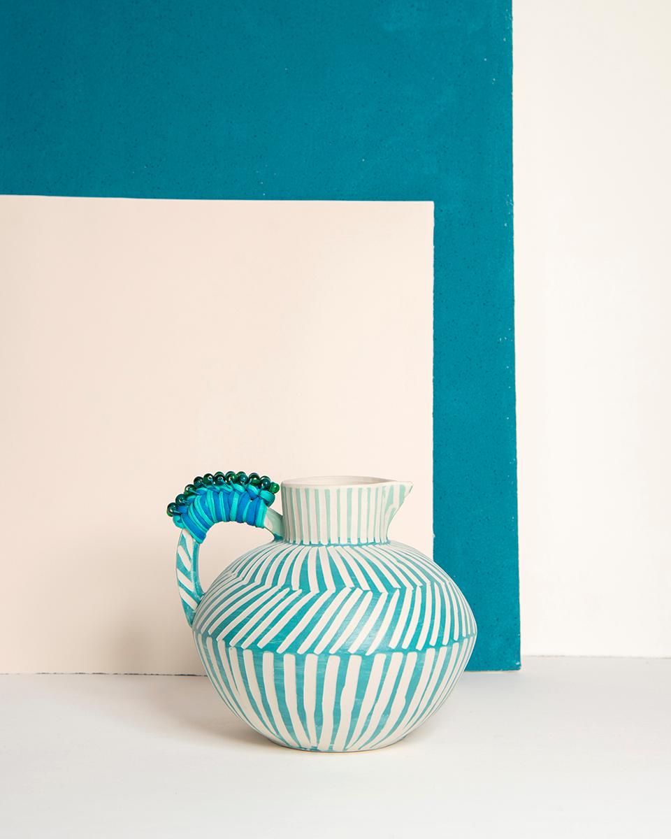 A handmade jug for your next soiree
Invite rustic charm to your kitchen with this Sea Blue Handmade Ceramic Jug. Handcrafted with artisanal craftsmanship and glazed with colorful stripes, this one-of-a-kind pitcher is perfect for storing and serving