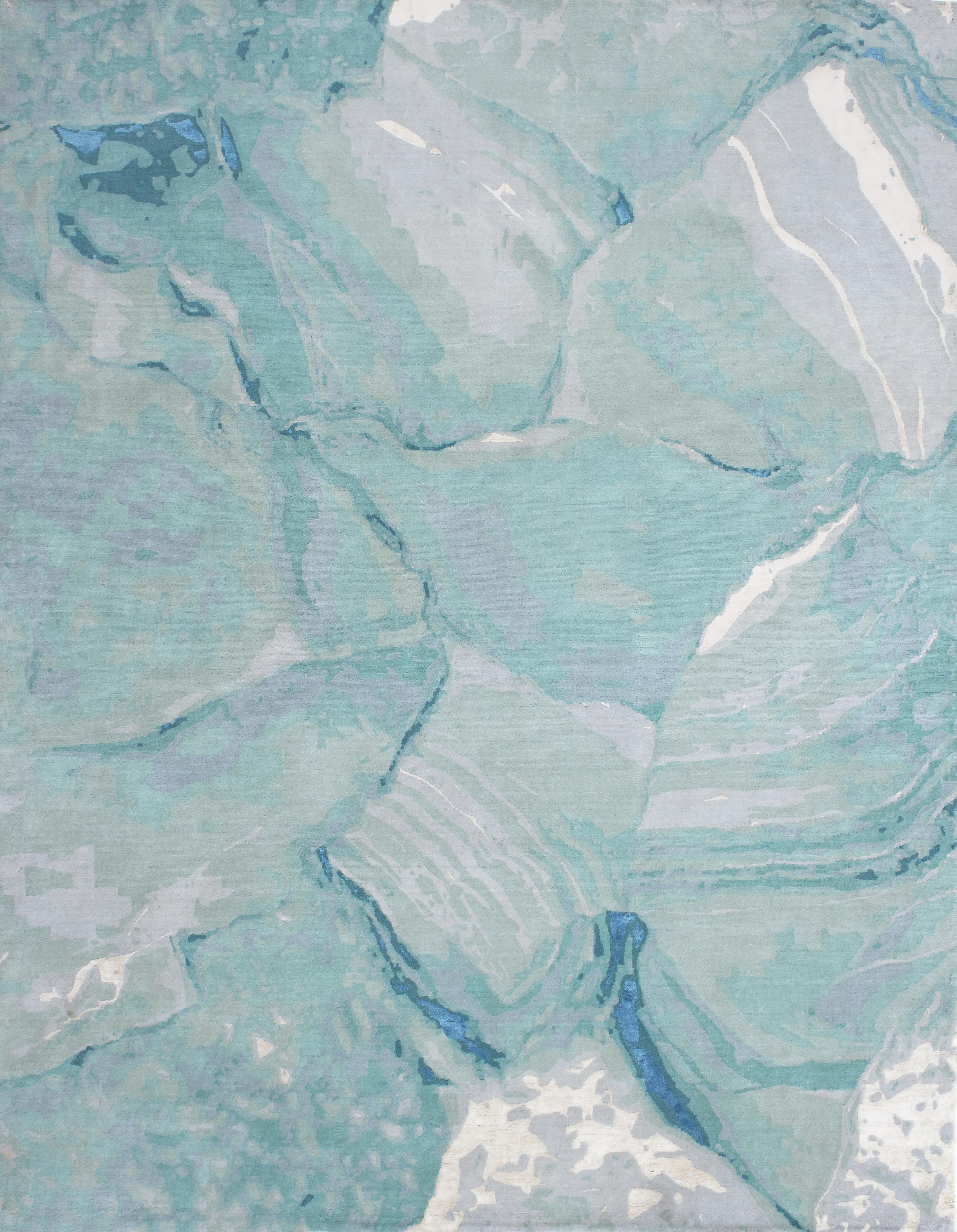 This whimsical rug is made of a delicate blend of hand knotted Tibetan wool and fine silk. The striking abstract design is inspired by the aquamarine pleasures surrounding the painting depicting a Californian swimming pool by David Hockney. The