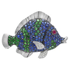 Spilla in oro bianco 18 carati con zaffiro blu, diamante, granato verde e rubino