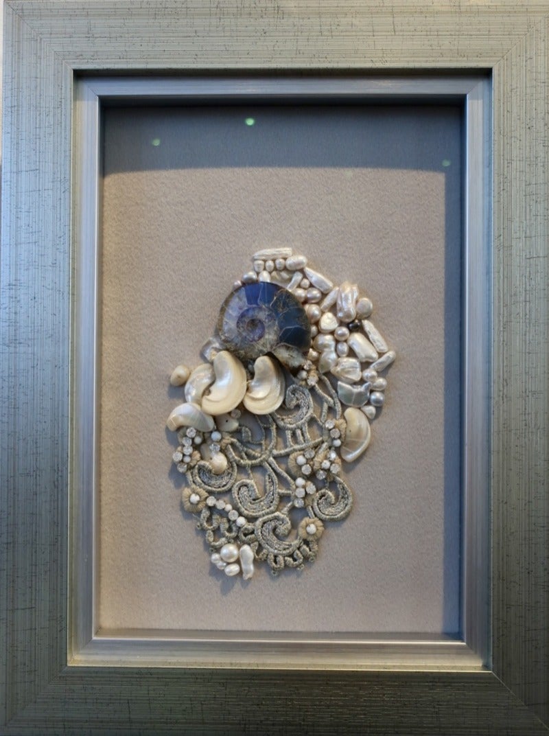 Crystal fossil, shells, and pearls with hand embroidered lace on cashmere base.
