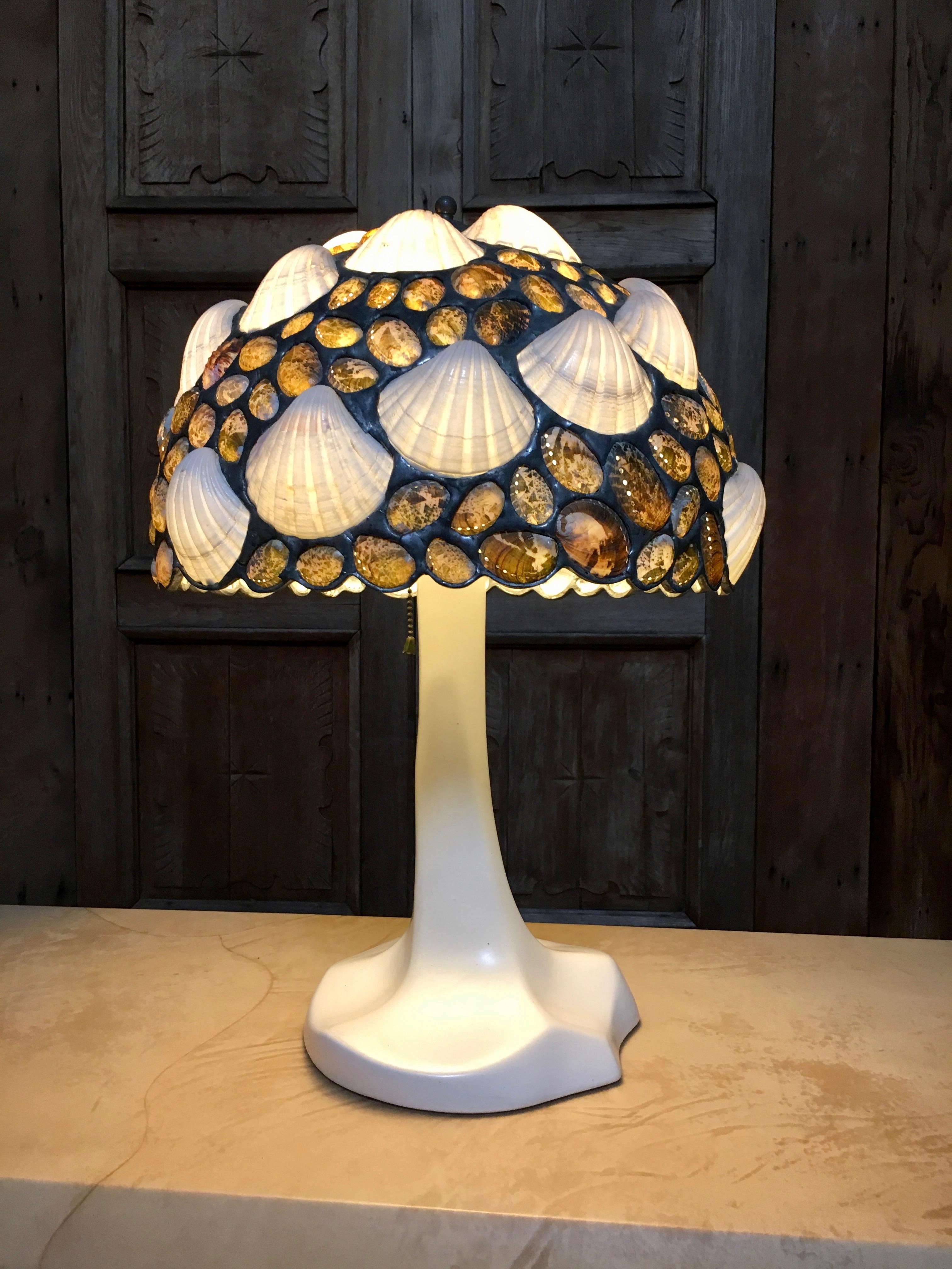 The grotto style shade was handcrafted with real shells by the late Jose Produit who came up with the idea and the base was crafted by John Perry
They Called it Seaform
There are less than 200 in existence.
They proved too expensive to produce.
 