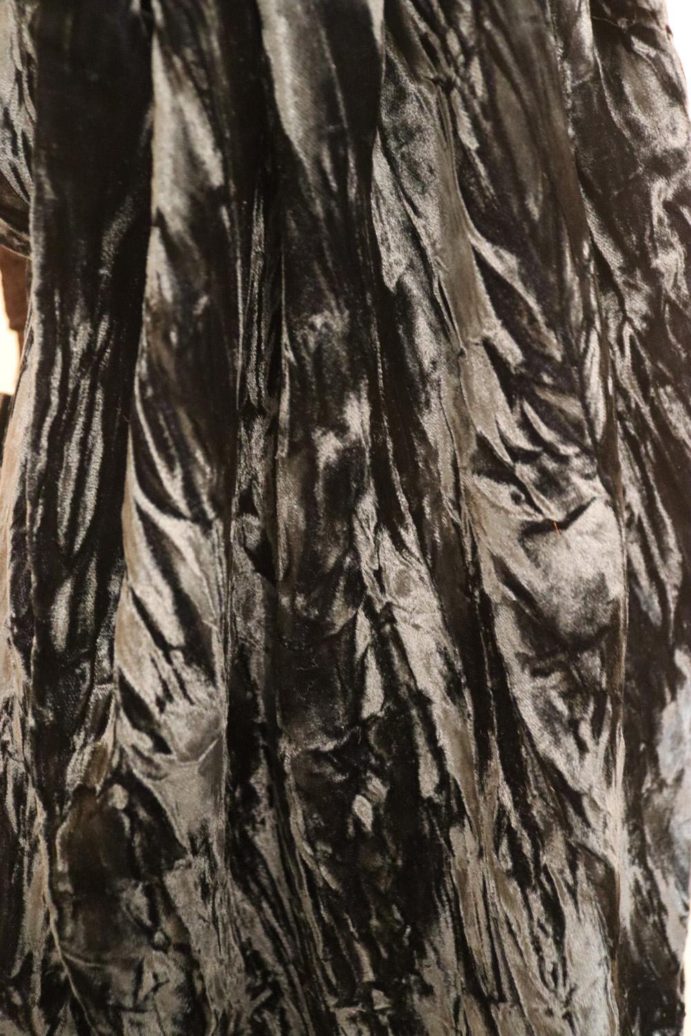 A wonderful  sea green silk velvet shawl. In a cross dyed silk velvet woven with two colours and then crushed in the mill, the opposing colours create an iridescent effect that glistens in the light. The scarf is edged with amethsyts. 82% viscose ,