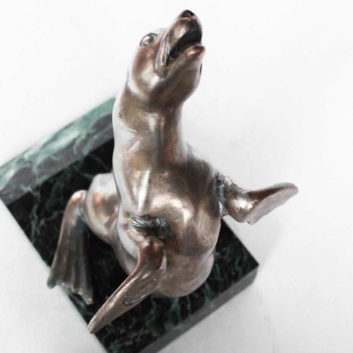 Art Deco, silvered spelter sealion bookends on an original marble plinth. Foundary seal too flipper.

Dimensions: H 21cm, W 13cm, D 9cm

Origin: French

Date: circa 1935

Item No: 2808194.
