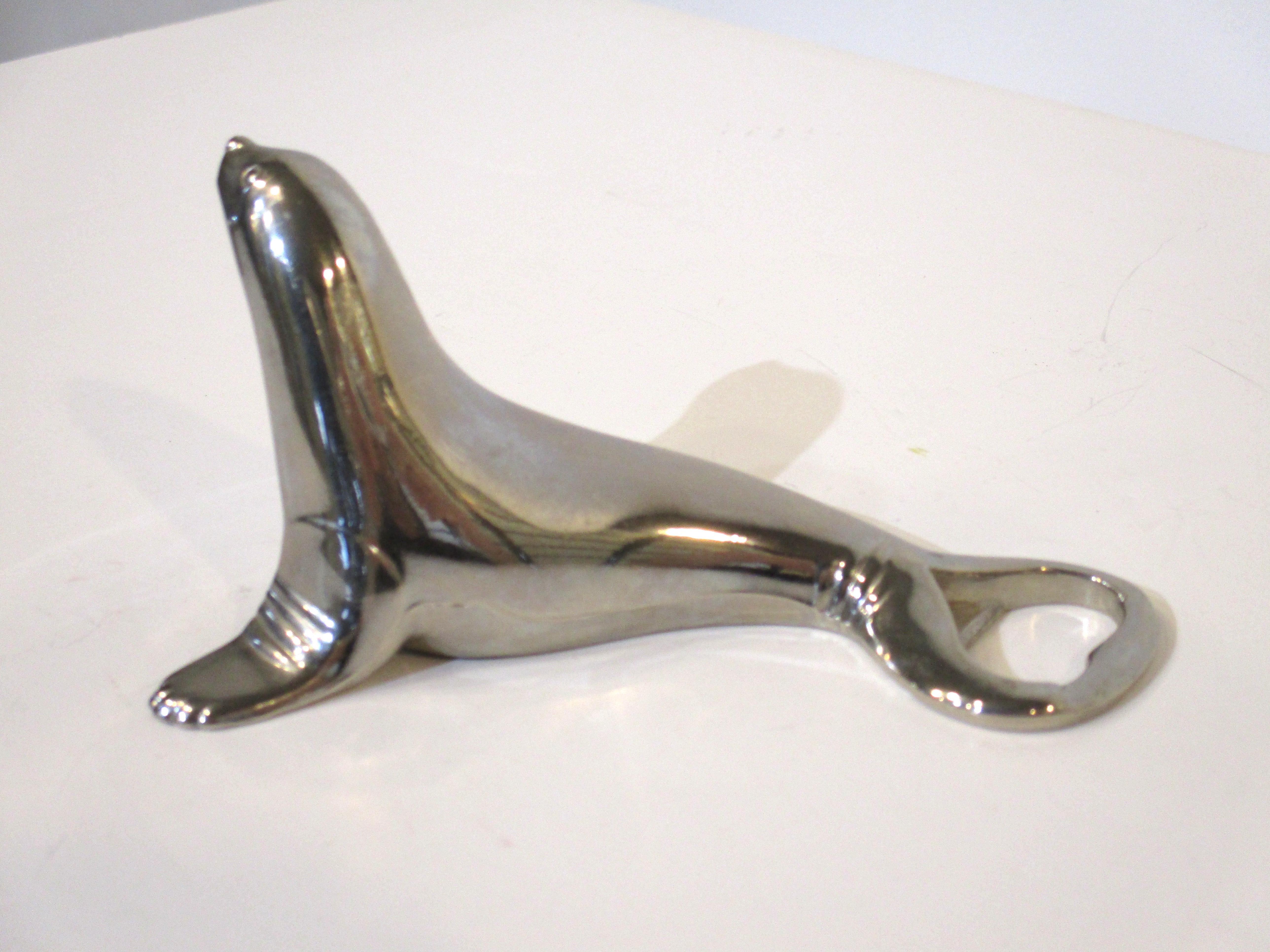 A cast chrome metal bottle and cap bar tool in the form of a sea lion, a fun accessory for you bar or kitchen or just a seal lover. Marked to the underside manufactured by BMF Western Germany.