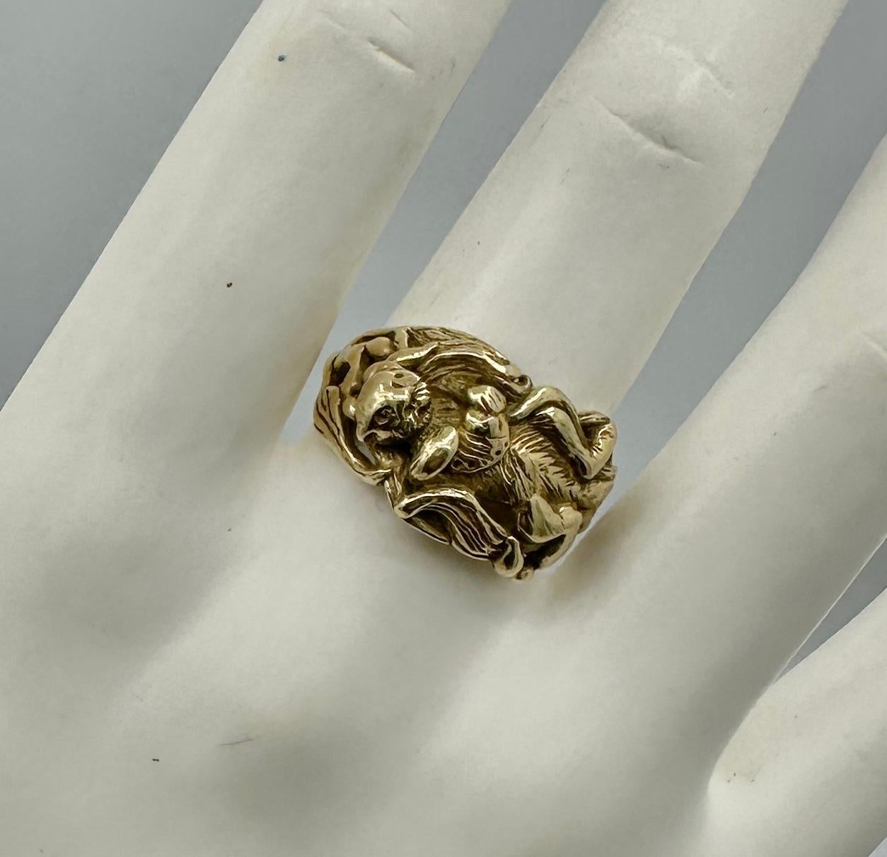 This is an absolutely wonderful antique Sea Otter Ring with a fabulous sea otter lying on its back surrounded by floating kelp seaweed and holding an abalone shell.  The ring is heavy solid 10 Karat Yellow Gold.  The ring has the most adorable sea