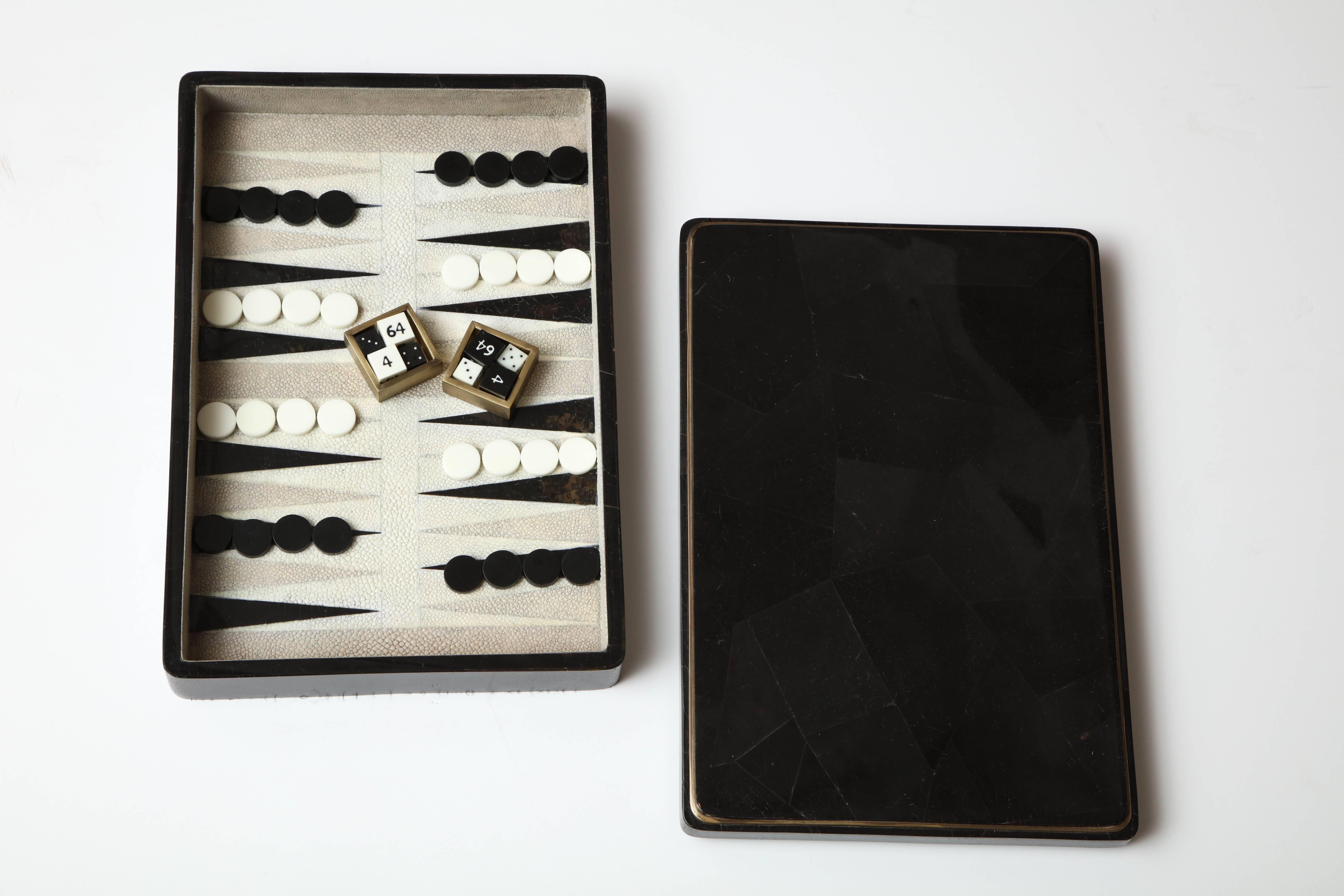 Decorative backgammon game designed in black sea shell and shagreen. Detail around the box is made of brass. Designed in France. Delivery time is about 12 weeks.
This is a great gift.