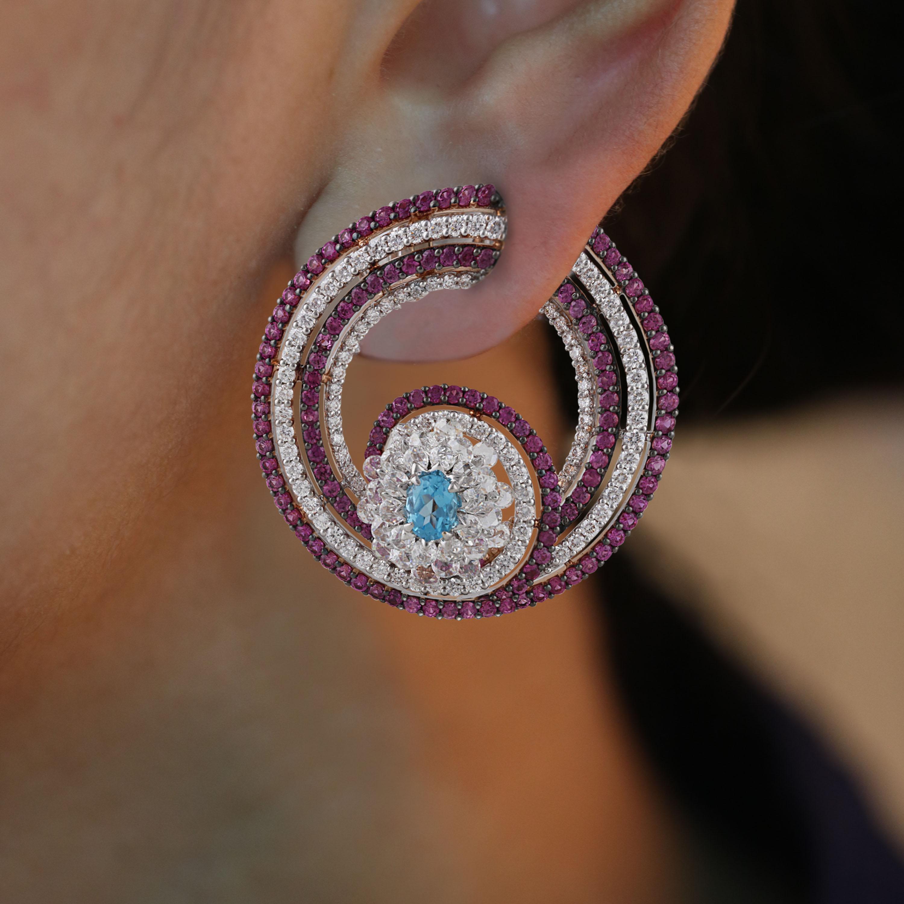 Gross Weight: 24.84 Grams
Diamond Weight: 3.63 cts
Pink Sapphire Weight: 3.95 cts
Blue Topaz Weight: 0.83 cts
IGI Certification can be done on Request.

Video of the product can be shared on request.

These hoop earrings mimic the delicacy and