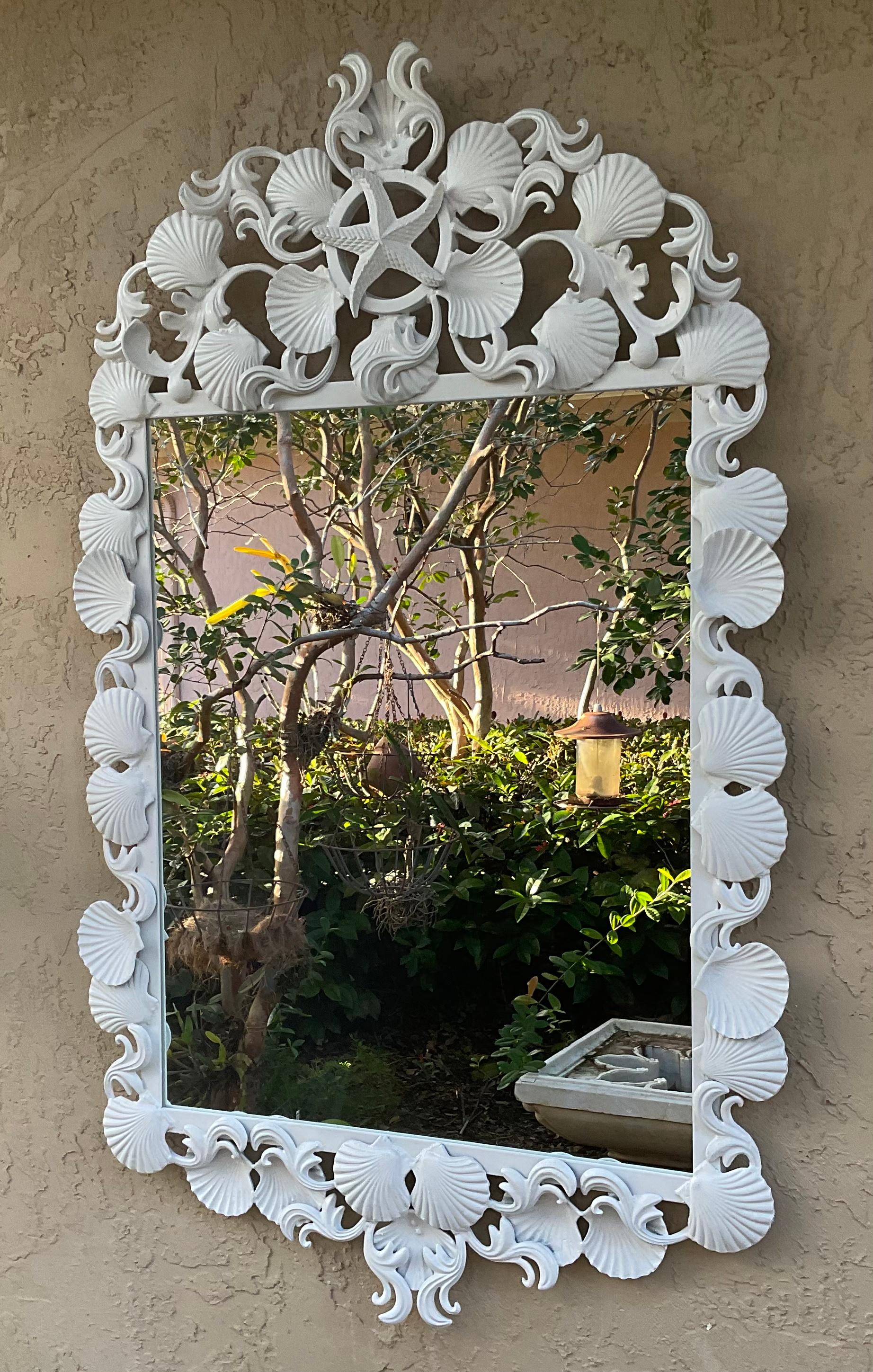 Exceptional mirror made of iron, artistically decorated with seashells and sea star motifs, painted with white acrylic paint .
Exceptional object of art for wall display.

Actual mirror size: 22”.5 x. 28.5.