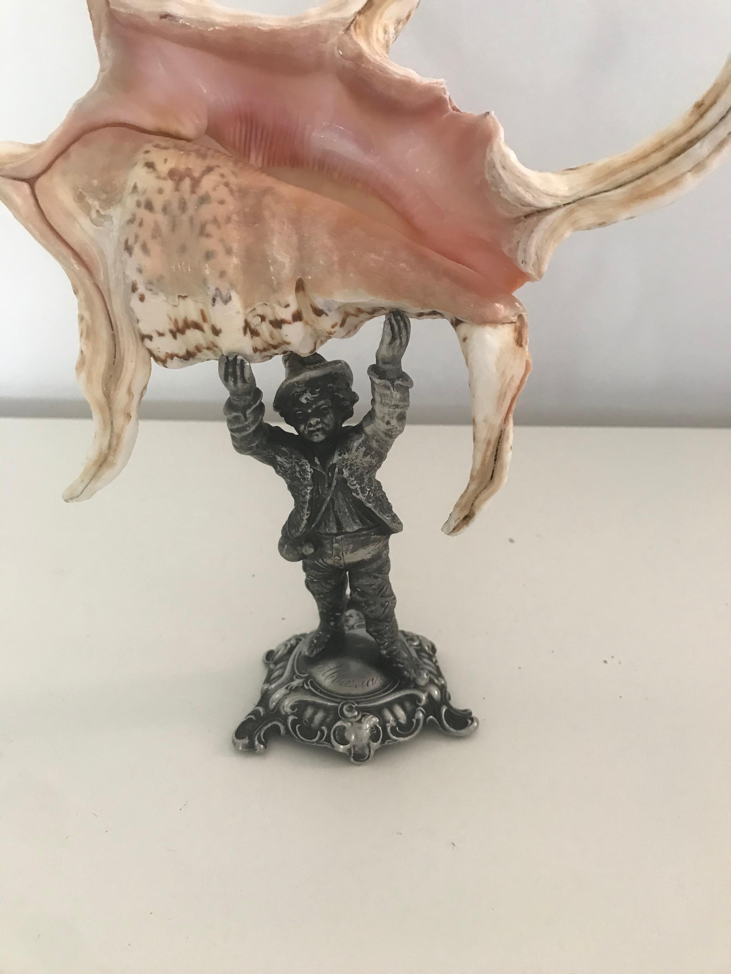 Antique sculpture stand with sea shell.