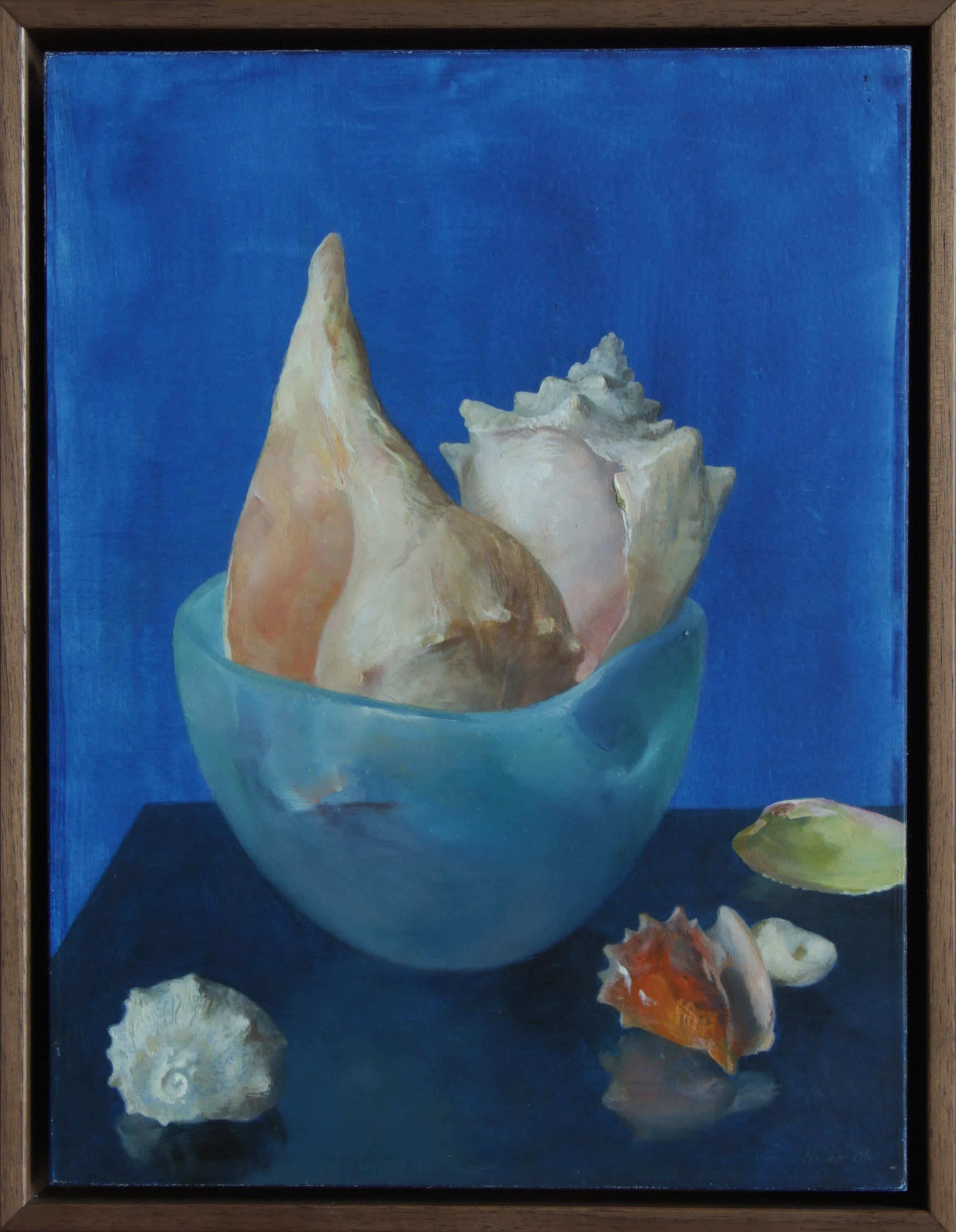 This delicately rendered painting presents the viewer with a study in contrasts. A collection of 6 seashells are arranged in a setting with three differing shades of blue. The shells are arranged, some in the ceramic glazed bowl and some sitting