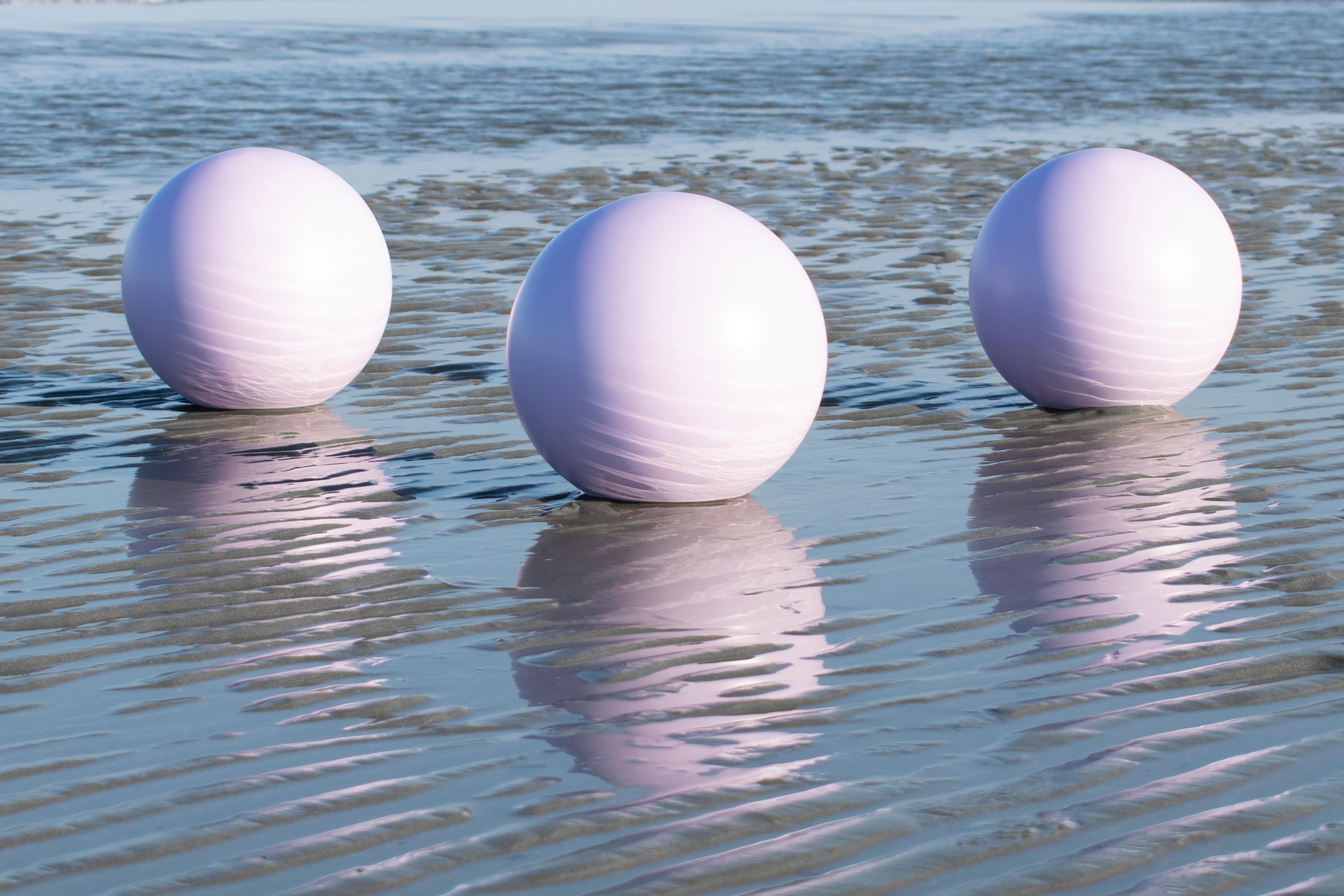 Silver Alpi Veneer attached on solid wood pastel lilac lacquered spheres.

This table is the pilot piece of the series, conceived as a notional subtraction of the sea. The intriguing patterns of the timber surface appear as imaginary reflections of