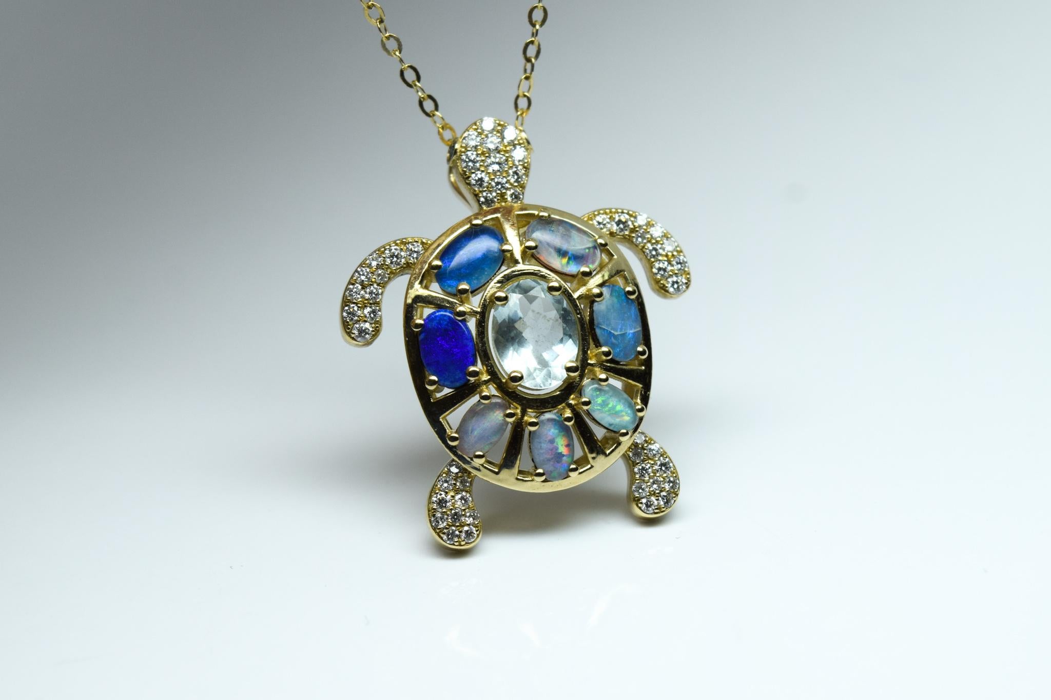 What an incredible piece of jewelry, its a beautiufl turtle made with aquaamrine and natural Australian opals and sparkling diamonds (Vs clarity, F-G color) the metal is 14KT gold and the chain is 18