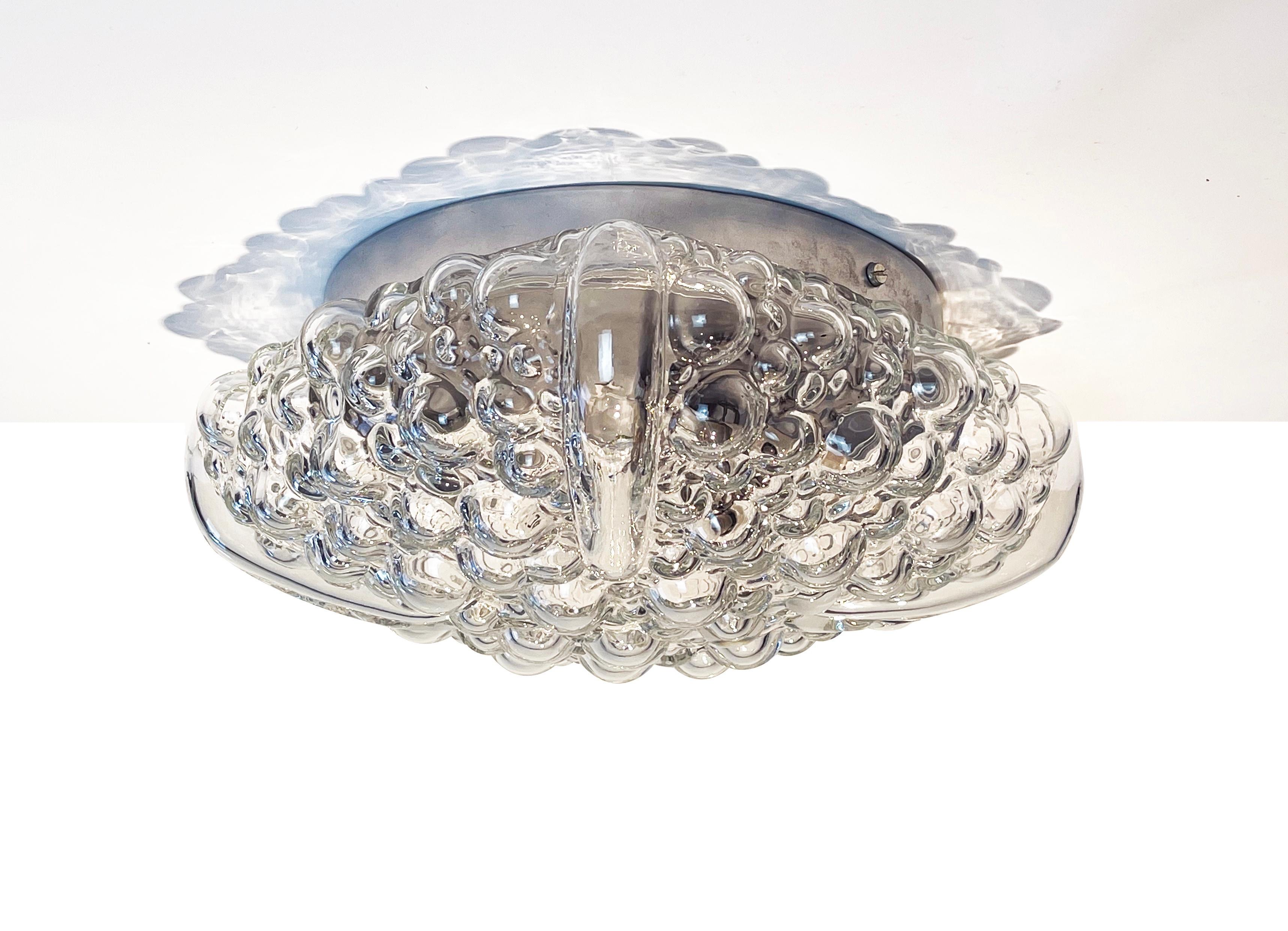 Magnificent, flush base ceiling or wall lamp by ''Hustadt Leuchten'', one of Germans famous mid century manufacturer of high-end design lighting.
Comes in a slightly square but round bubble sea urchin shape and design.

The funky glamorous glas