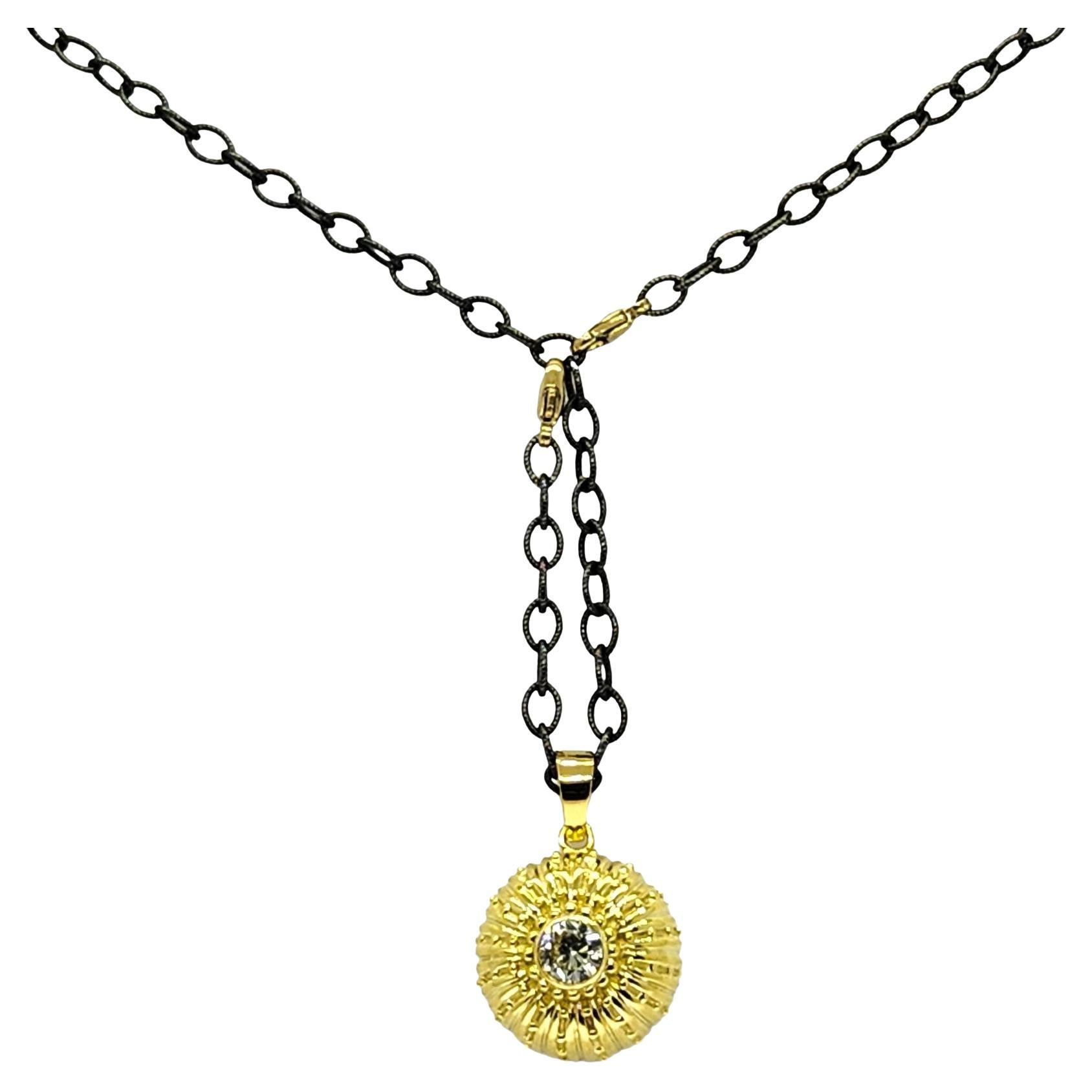 Beautifully textured Sea Urchin pendant with ribs and beading create a luxury look. The center of the Sea Urchin has a white round Brilliant cut diamond that is bezel set, our largest diamond in a necklace. 
The chain is a rebellious edgy
