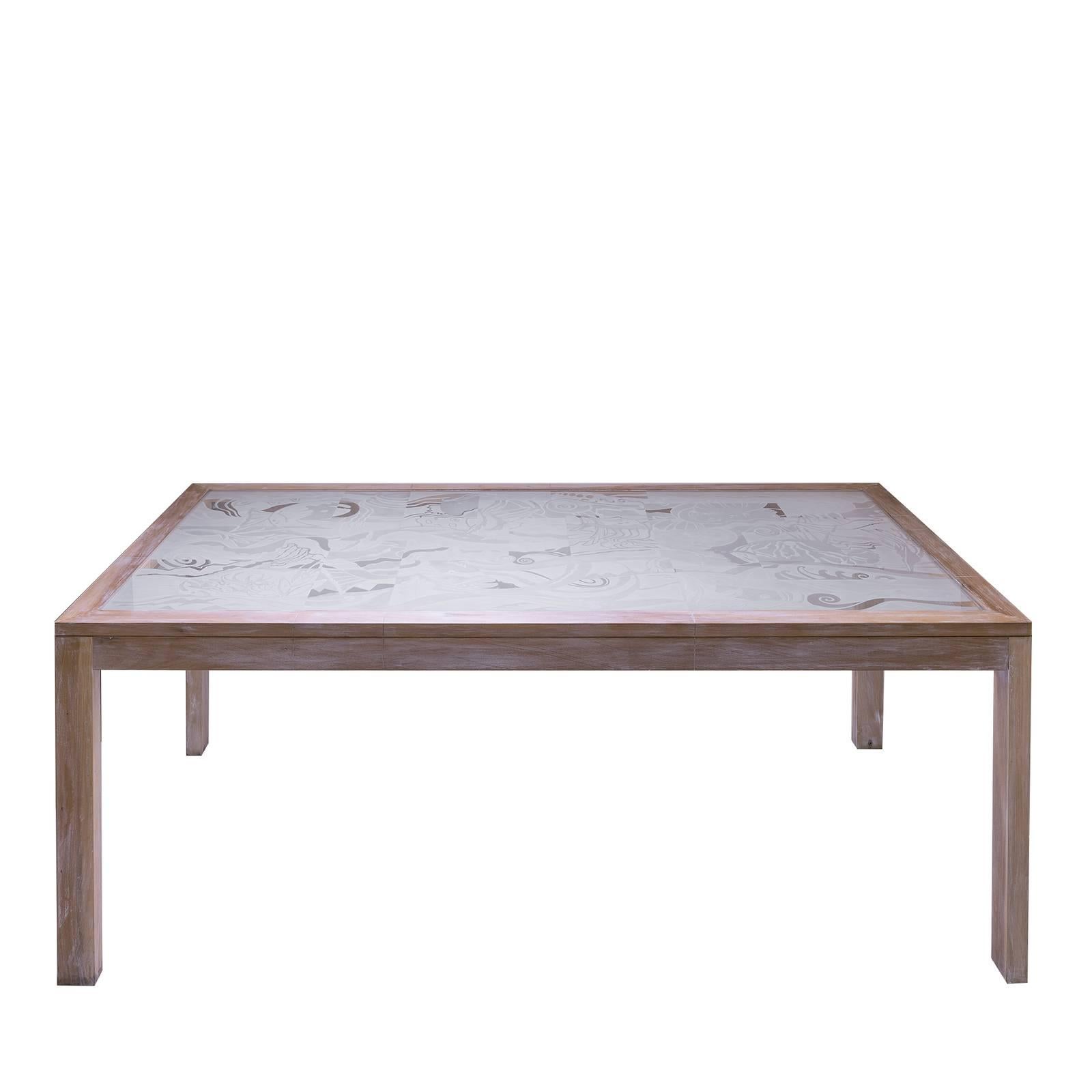 An exquisite reinvention of classic silhouette, this glass table will infuse contemporary flair and refinement into any modern decor. Framed by a lightweight wooden structure, the glass table top features a bas-relief design of a stormy sea filled