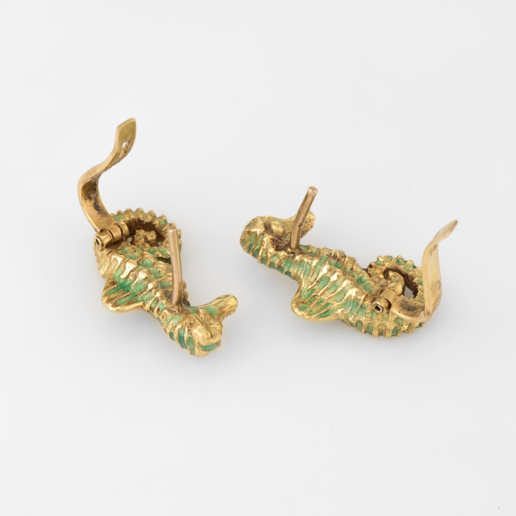 Finely detailed pair of seahorse earrings, crafted in 18k yellow gold. 

Two old mine cut diamonds are embedded into the eyes and total an estimated 0.04 carats (estimated at I color and SI2 clarity). 

Lifelike textured design overlaid with green