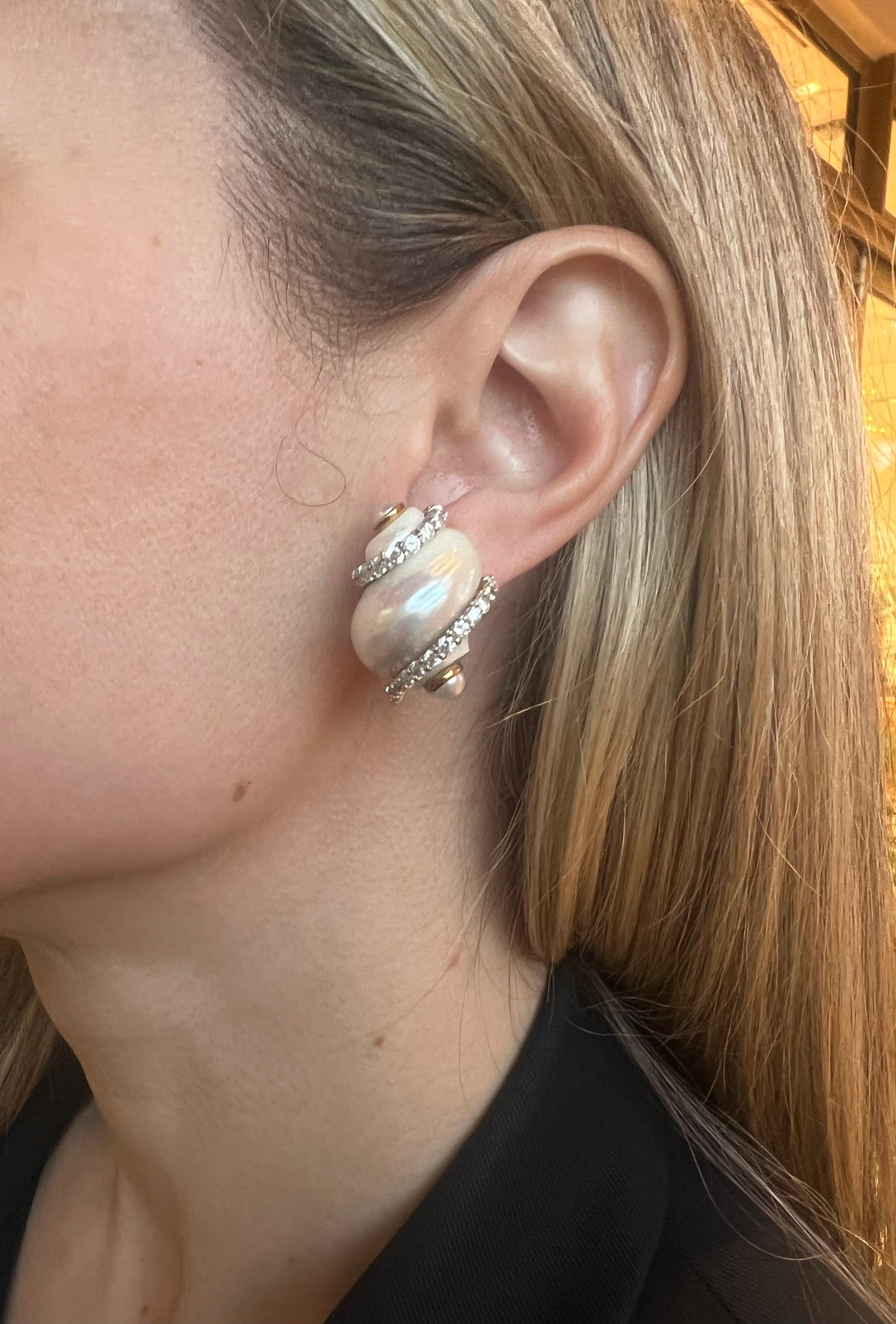 Classic turbo shell earrings by Seaman Schepps set in 18 karat yellow gold with diamonds. Turbo shells wrapped by forty-eight brilliant cut diamonds totaling 1.44 carats. Each accented with  5mm cultured pearl end caps. Length 1
