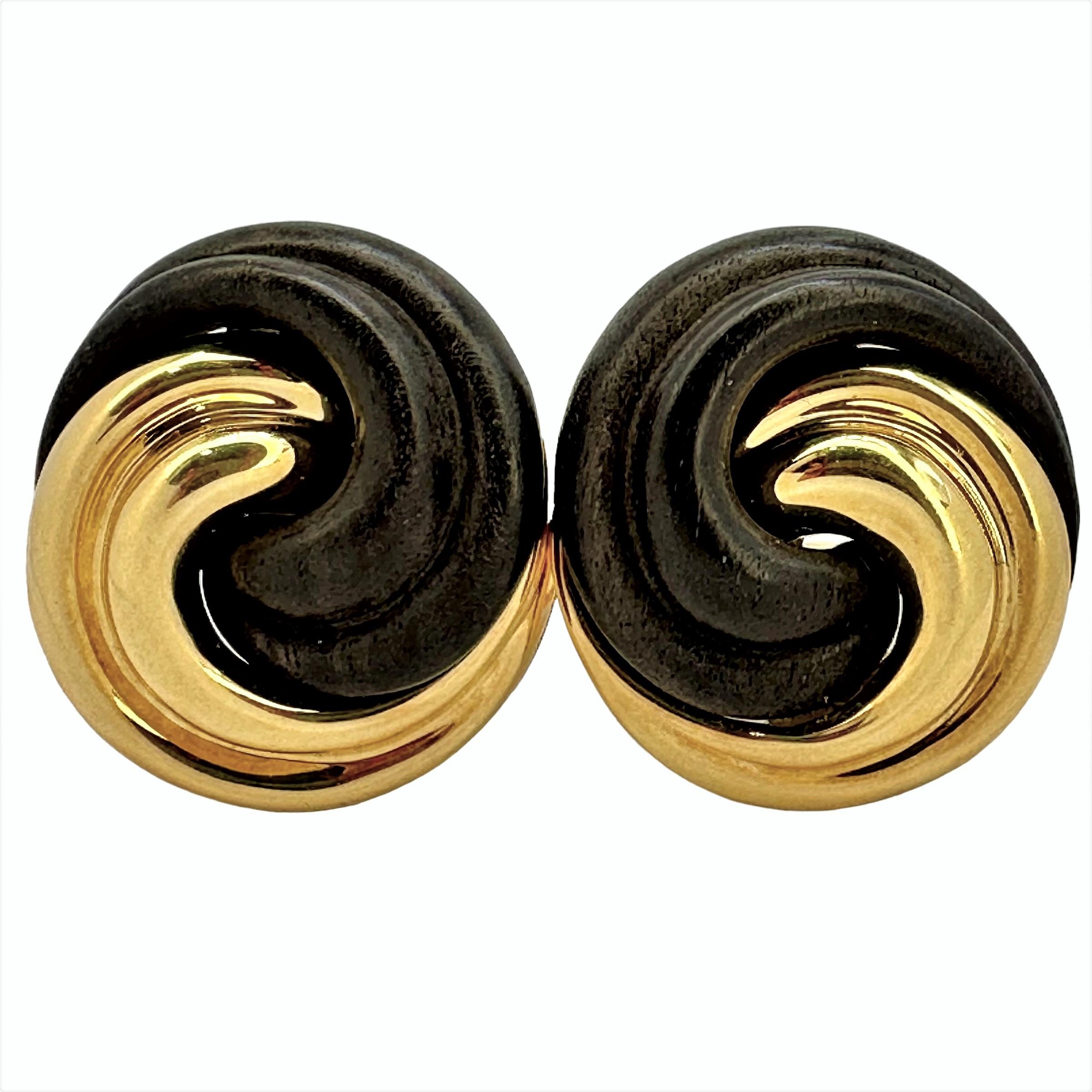 This lovely, tailored and sculptured pair of Seaman Schepps designer earrings are remarkable in their simplicity and impact. Each consists of one fluted 18K yellow gold panel entwined with an opposing fluted rosewood panel.  Length is 1 1/16 inch