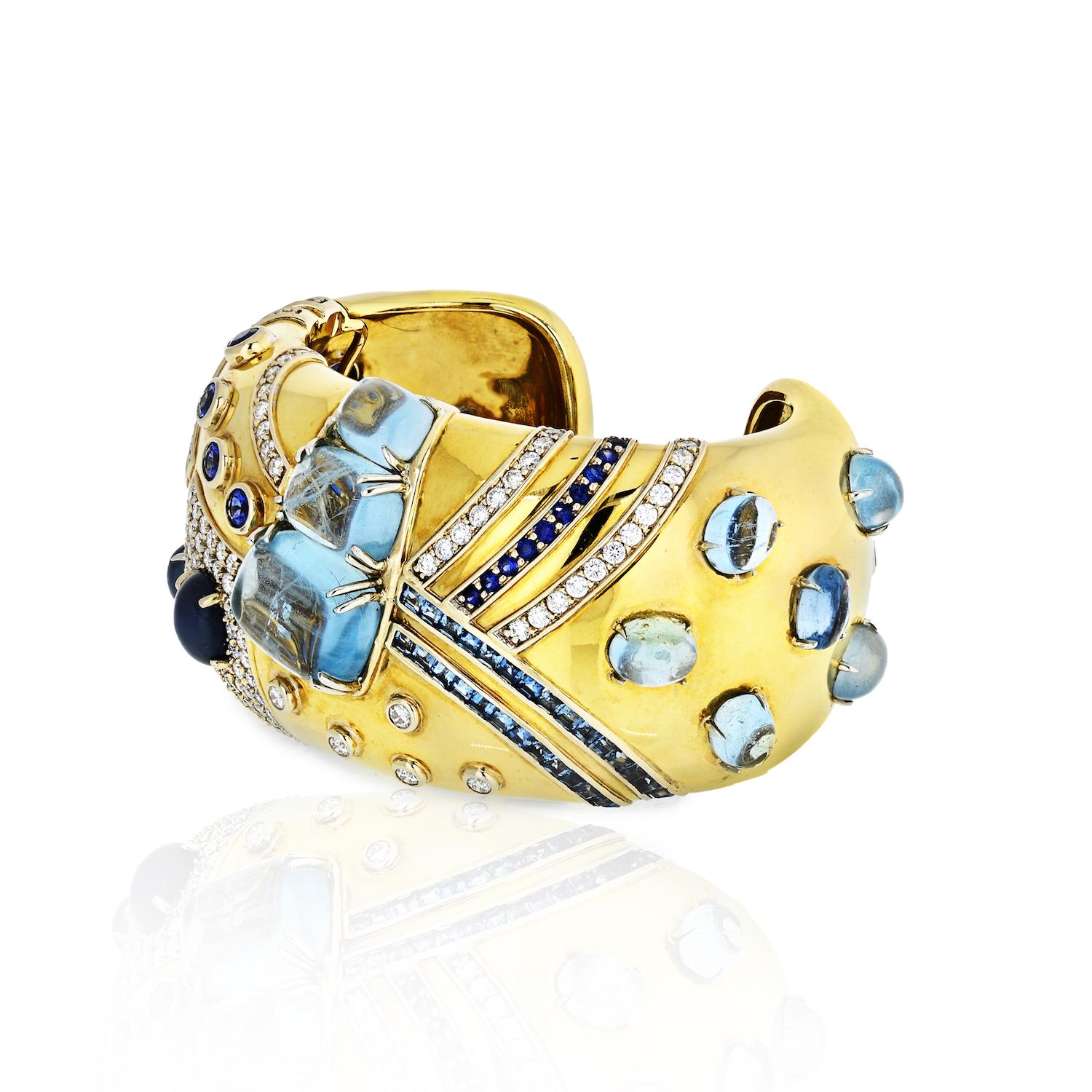 A Jazz Cuff in Aquamarine, Sapphire, and Diamond set in 18K Yellow Gold.  Signed Seaman Schepps.
