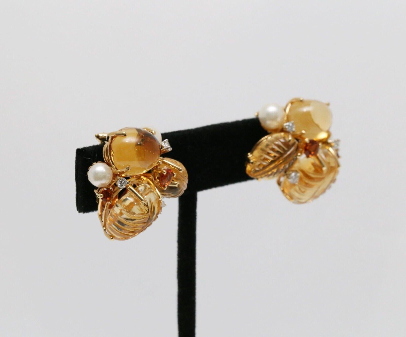 Known for their bold color combinations and innovative designs, this stunning pair of Seaman Schepps earclip earrings are crafted from a high quality 18k yellow gold. These earrings feature six natural diamonds, three on each pair, in addition to