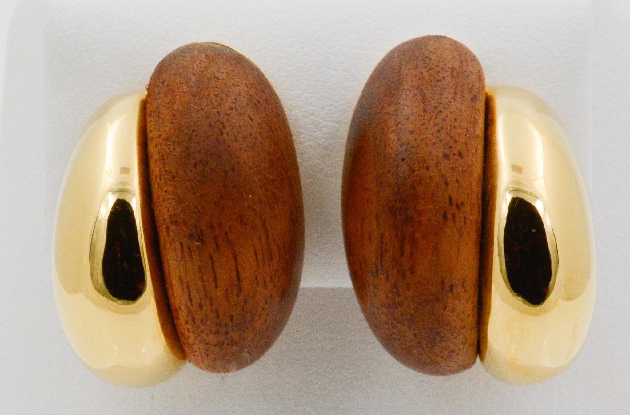 From Seaman Schepps, these Silhouette earrings feature a half 18 karat yellow gold and half walnut wood design with clip back. Signed Seaman Shepps. 