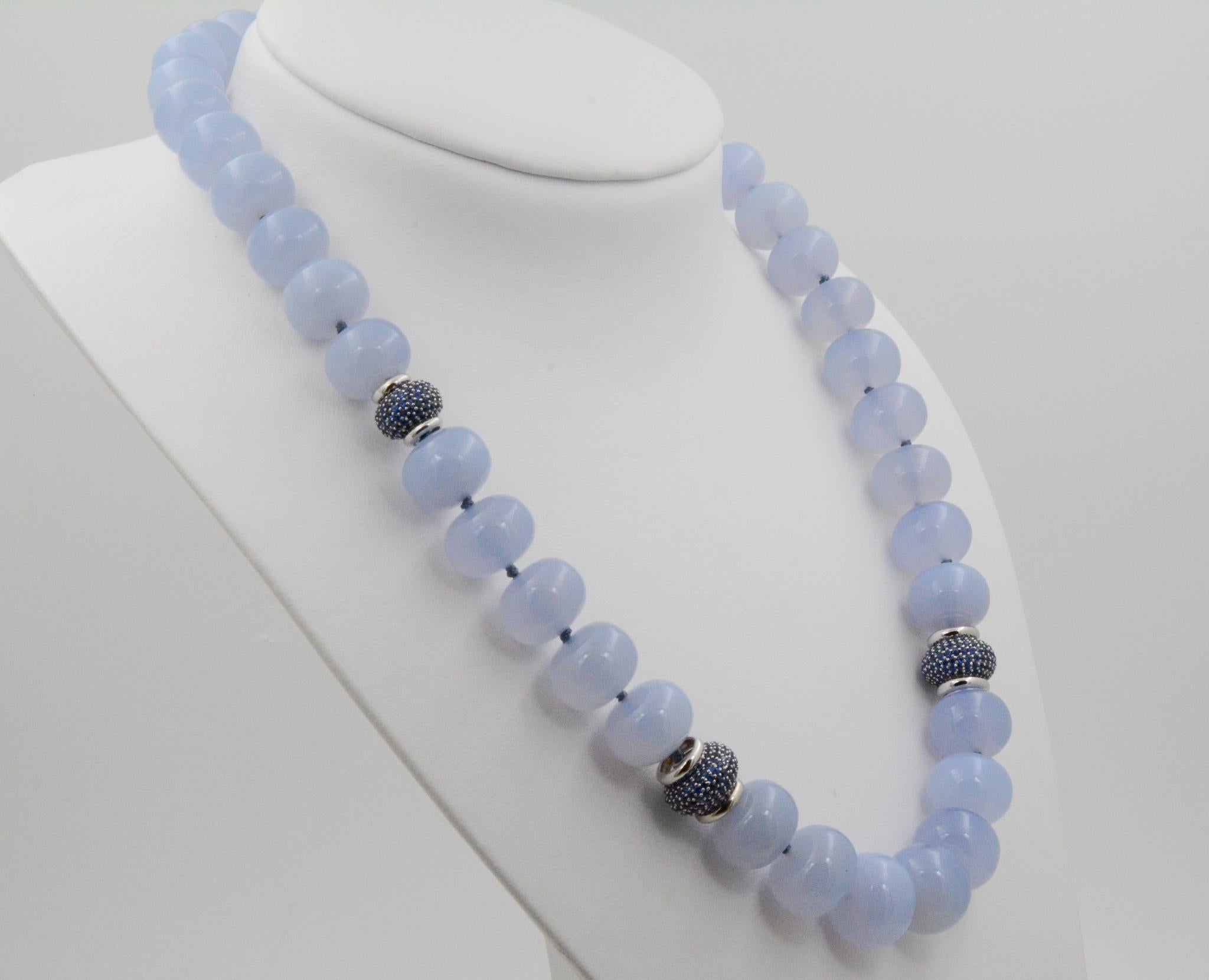 From Seaman Schepps, this 20 inch 18 karat white gold necklace features blue chalcedony beads with pave sapphire rondelles. It is paired with clasps set in 18 karat white gold. The necklace is signed Seaman Schepps. 