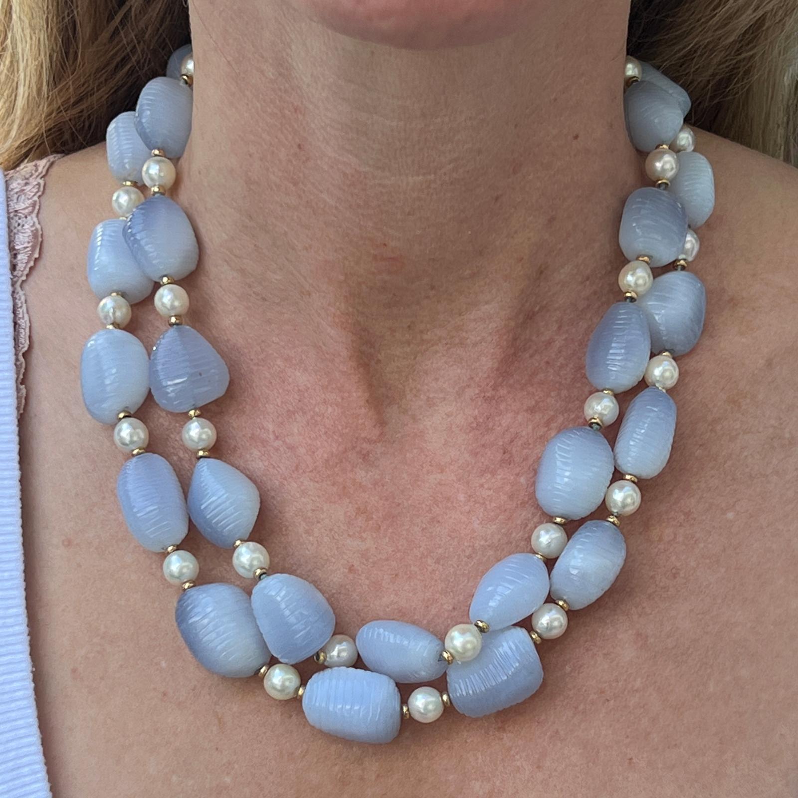 Designer blue chalcedony and cultured pearl necklace by Seaman Schepps fashioned in 18 karat yellow gold. The nesting necklace is versatile and can be worn as two separate pieces or one long necklace. One measures 20 inches and the other 18 inches-