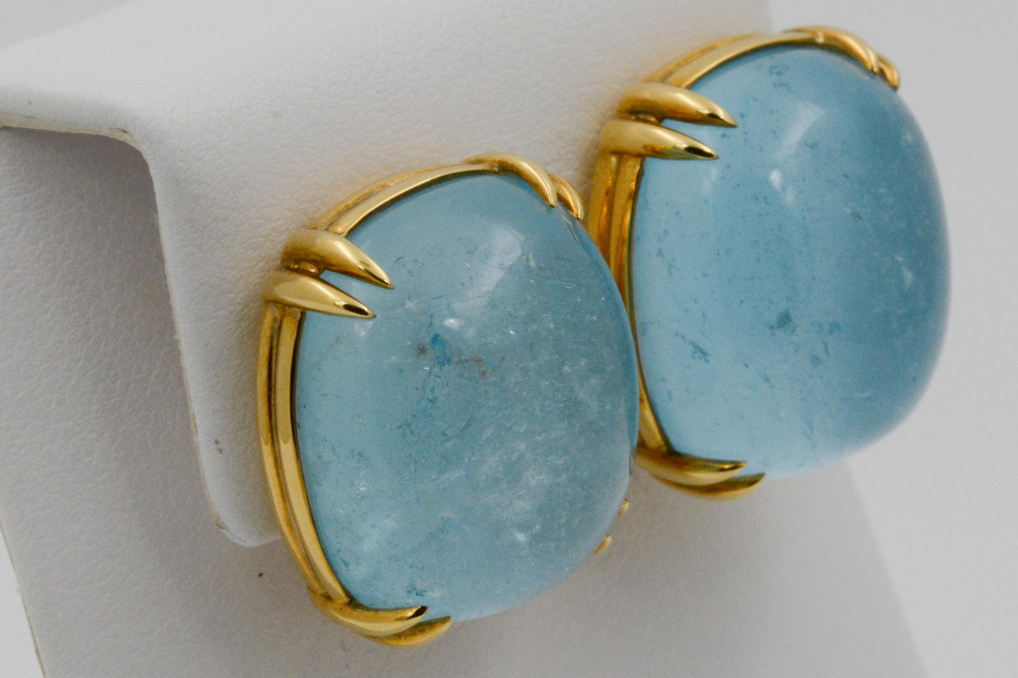 From Seaman Schepps, these Capri 18k yellow gold earrings feature blue topaz and are signed Seaman Schepps. 