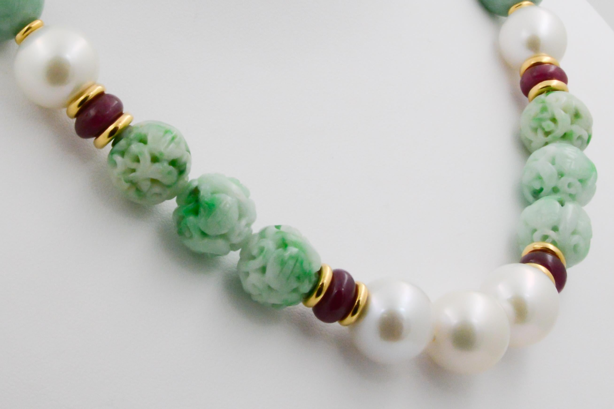 From Seaman Schepps, this carved jade, peal and ruby beaded canton necklaces are a charming pair that brings a pop of color to any look. Measures at 17” and has eight carved jadeite beads, 12 smooth jadeite beads, 11 pearls and four ruby beads with