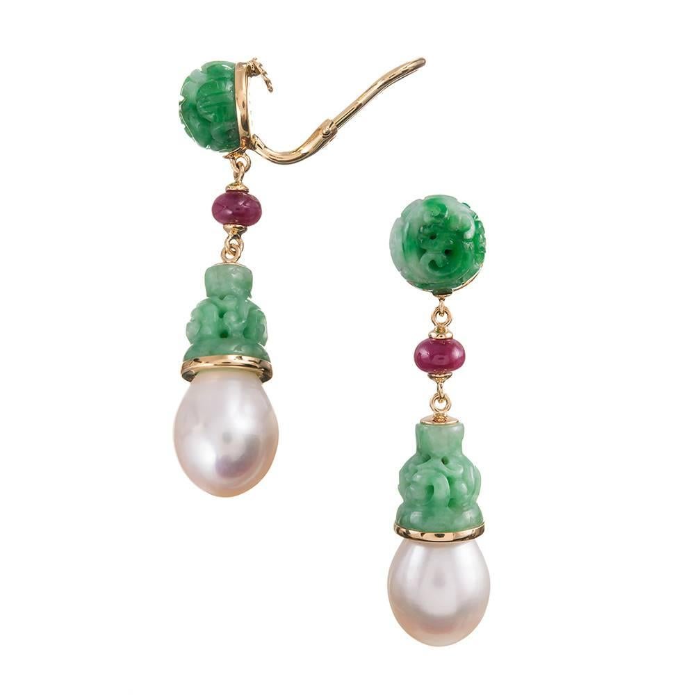 A two inch long stack of carved jadeite and ruby, compliments of American jewelry icon Seaman Schepps. The rubies weigh 2.98 carats. Mounted in 18k yellow gold and currently clips, however a post can be added on request.