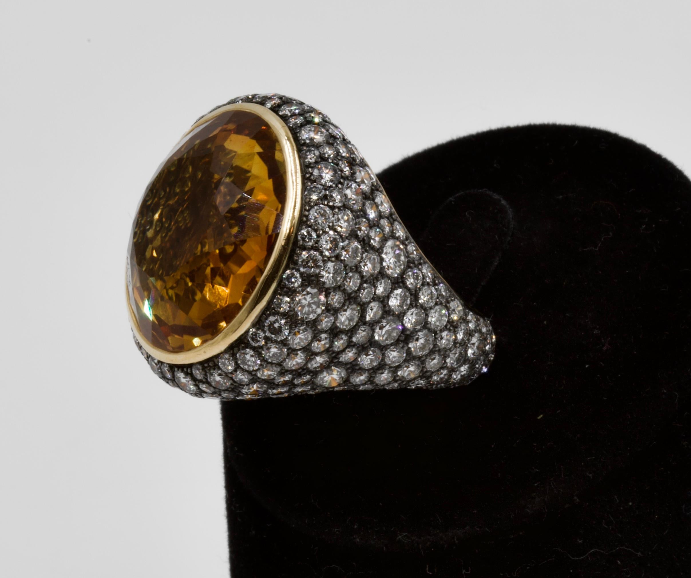 Exceptional Seaman Schepps Vintage Citrine and Diamonds Cocktail Ring at Second Petale Gallery

18k yellow and black gold (French mark)
Circular-cut citrine, approx. 19-22 ct. 
Diamonds approx. 12-14 ct. 
Signed and numbered.
Size: 53
Weight : 17,53