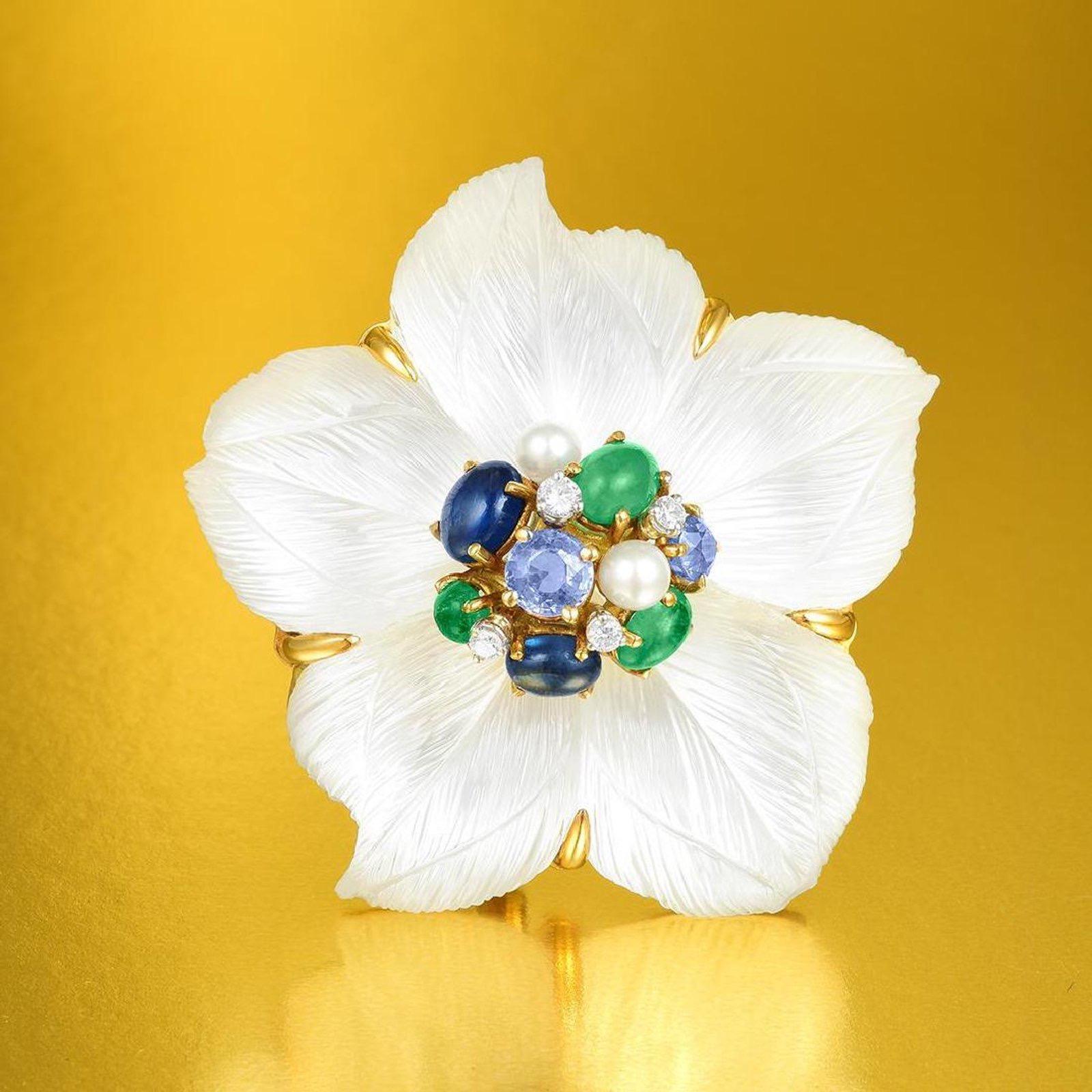Seaman Schepps Clematis flower brooch in 18kt yellow gold with hand-carved rock crystal with mother of pearl underneath, sapphires, cultured pearls, diamonds and emeralds.