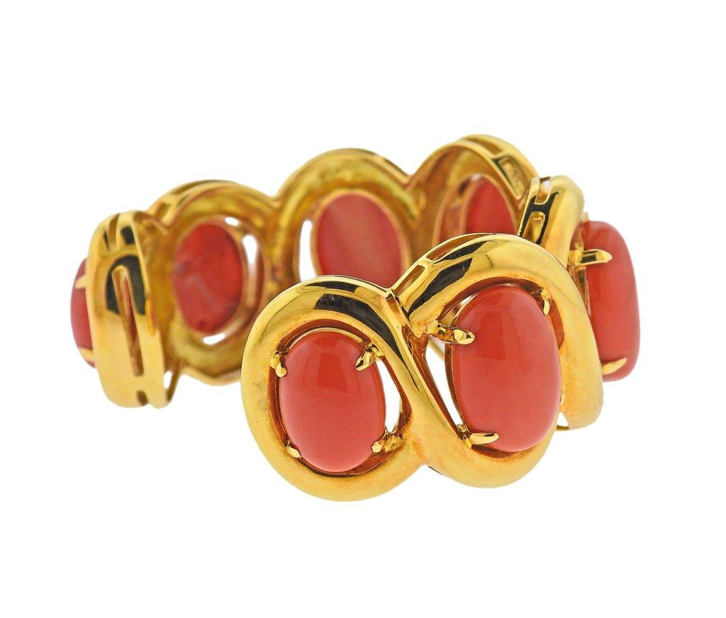 18k gold cuff bracelet by Seaman Schepps with 5 corals, measuring from 16mm x 12mm to 25mm x 18mm. Bracelet wil fit up to 7