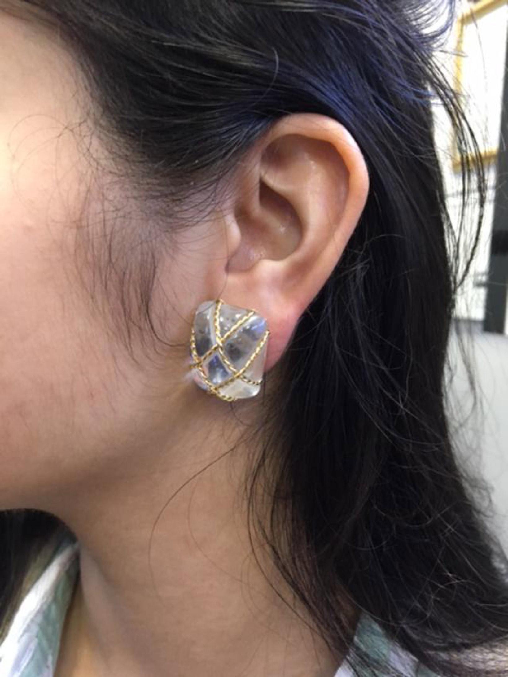 These chic elegant ear clips designed and manufactured by the renown 20th Century jeweler Seaman Schepps are a must-have for every day wear. Polished crystal with bands of braided 18 karat yellow gold give these earrings the perfect match to any