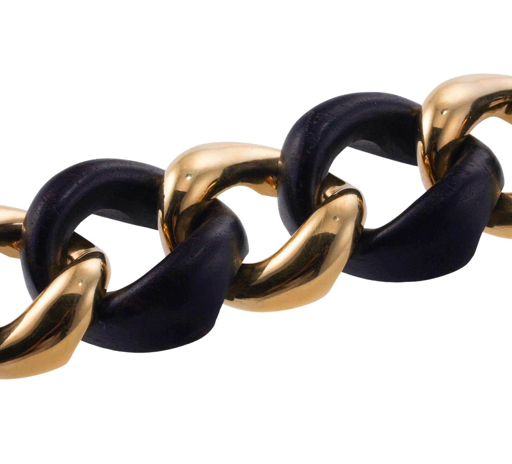Large link bracelet by Seaman Schepps in 18k gold and ebony wood. Bracelet measures 8