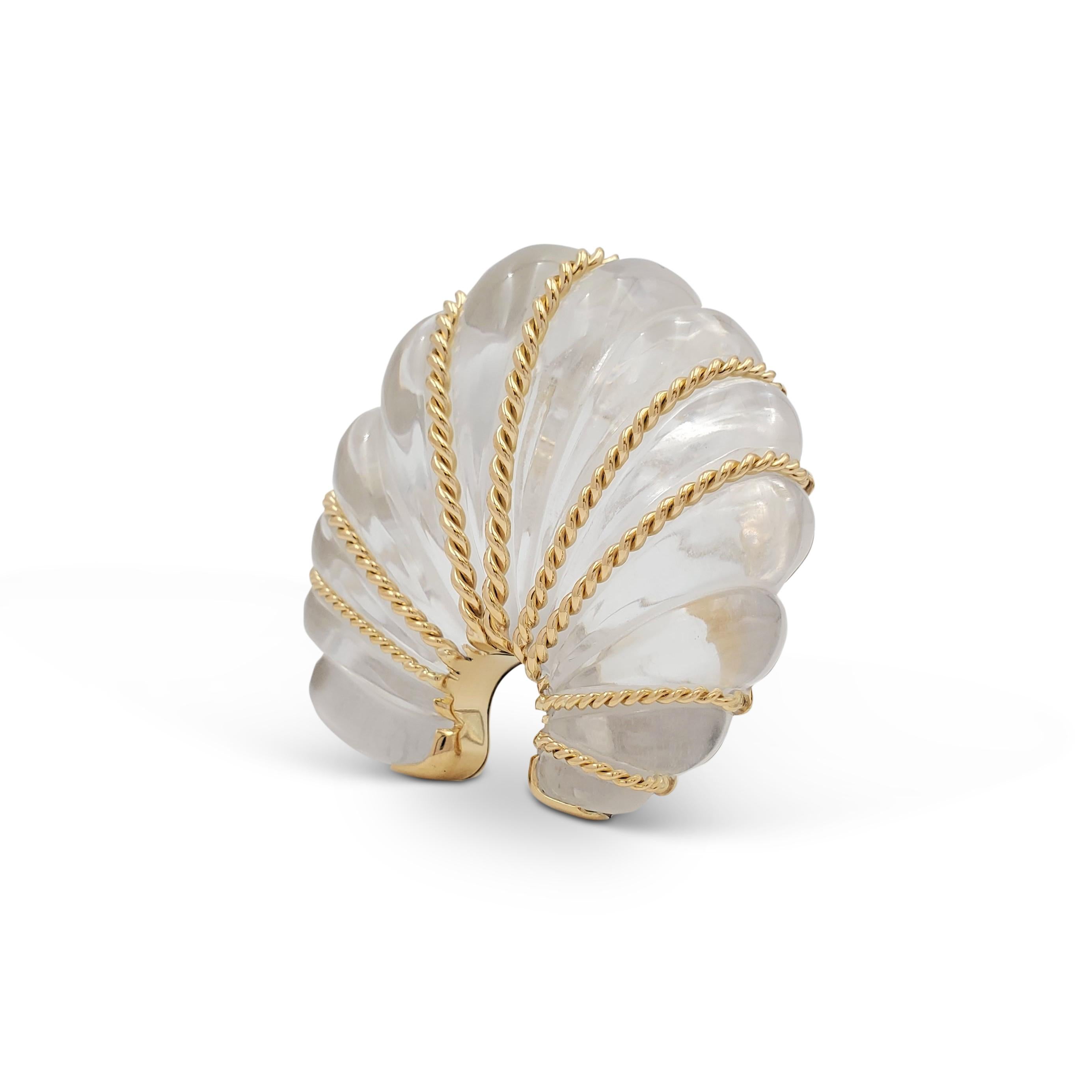Authentic Seaman Schepps brooch centering on a fluted clear crystal fan design with 18 karat yellow twisted wires. The rock crystal is set in 18 karat yellow gold. Signed Seaman Schepps, 750, with serial number. The brooch is not presented with the