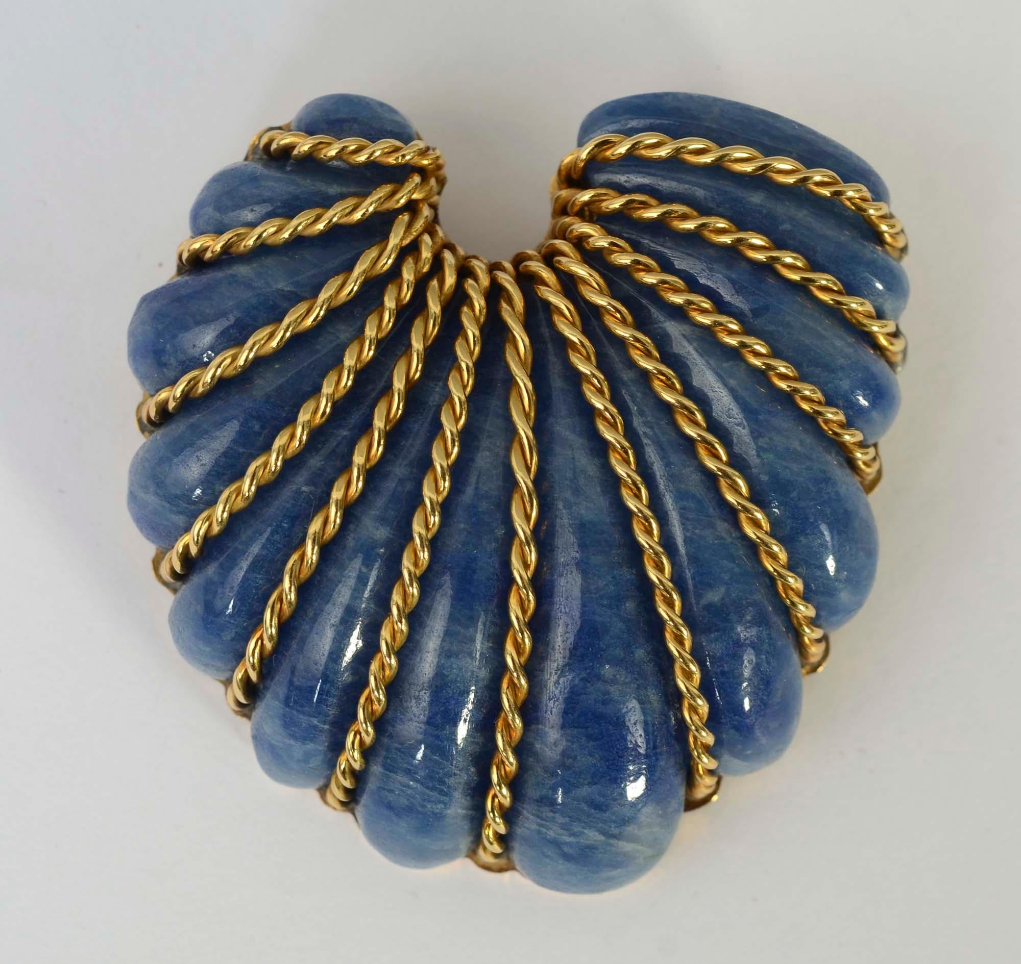 Seaman Schepps beautifully carved sodalite seashell brooch banded with 18 karat gold. The thirteen lobes of the shell are separated by twisted gold bands. The brooch measures 2 inches wide and 2 1/4 inches long.