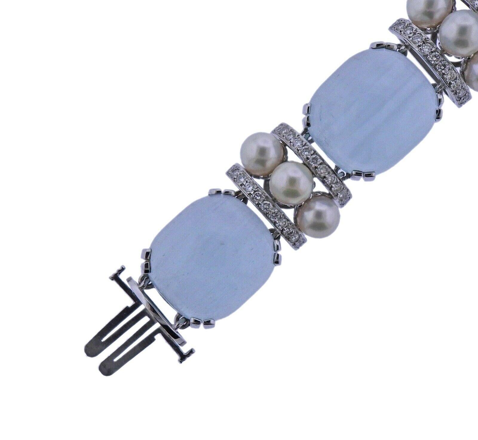 18k white gold bracelet by Seaman Schepps, set with approx. 2.00ctw in VS/G diamonds, 7.2mm pearls, and aquamarine cabochons. Bracelet measures 7 1/4 inches long, approx 19mm wide. Marked - Seaman Schepps 750 P9767. Weight -89.1 grams. 