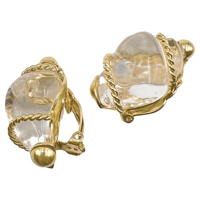 Shell form earrings, composed of carved rock crystal wrapped in rope-twist 14k yellow gold frame with 14k yellow gold domed tips.  Marked 'PSV' for Patricia Schepps Vaill of Seaman Schepps.  Circa 1972.  Measuring 1.25