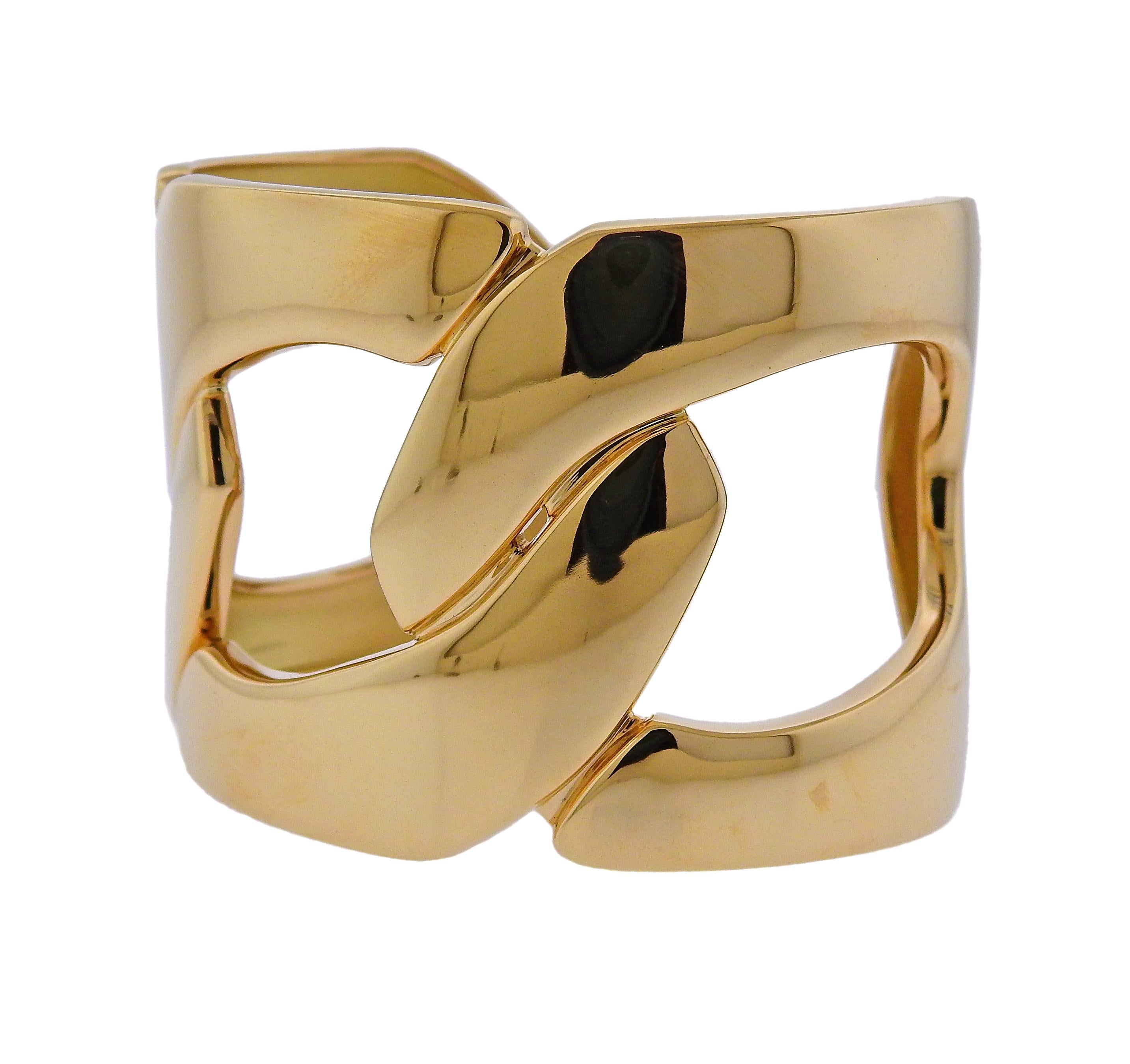Brand new 18k yellow gold wide cuff bracelet, designed by Seaman Schepps, featuring three interconnected links. Bracelet will fit approx. 7