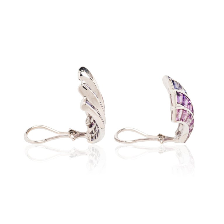 Bold designs and graphic lines are the hallmarks of iconic American jeweler Seaman Schepps. These elegant Deco-influenced Wave earrings feature modified square and trapezoid-shaped iolite and amethysts.

- .94” long x 1.00” wide
- Approximately 9.50