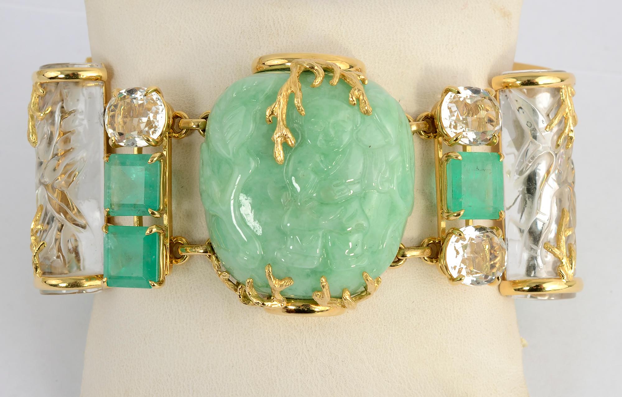 Exquisite and unusual bracelet by Seaman Schepps consisting of three carved jadeite jade snuff bottles that alternate with carved rock crystal bamboo columns. They are accented by gold branch design overlays. Between the snuff bottles and rock